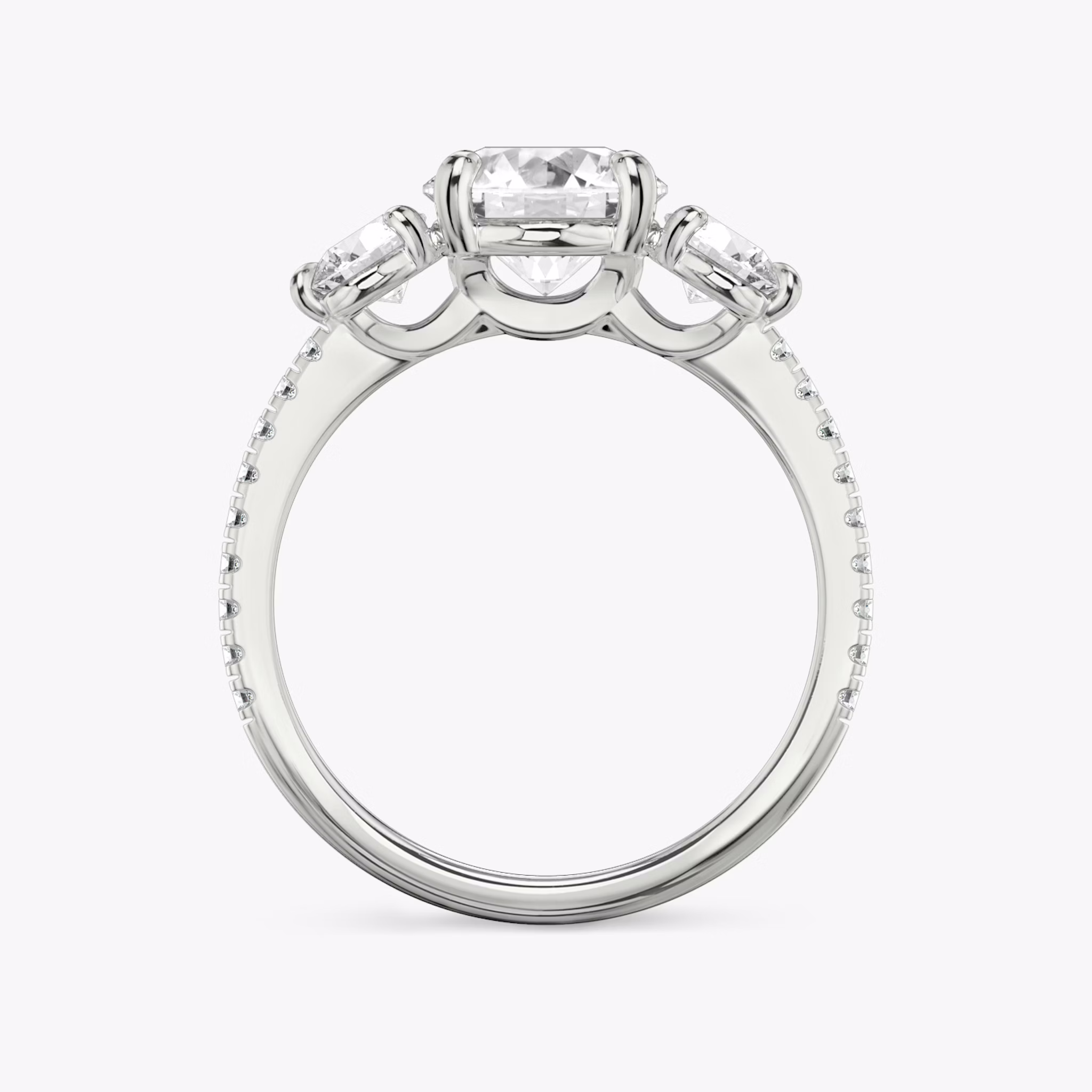 The Three Stone | Round Brilliant | 18k | White Gold | bandAccent: Pavé | caratWeight: other | sideStoneCarat: 0.25ct | sideStoneShape: Round Brilliant | diamondOrientation: vertical