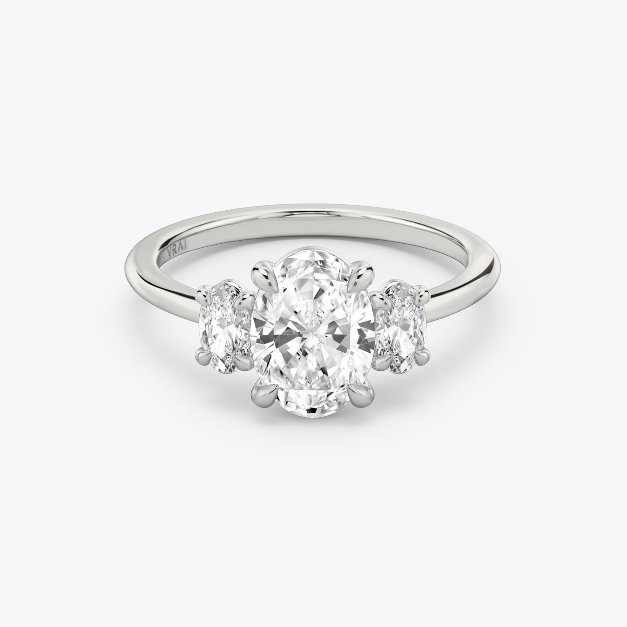 The Three Stone | Oval | 18k | White Gold | bandAccent: Plain | sideStoneCarat: 0.25ct | sideStoneShape: Oval | diamondOrientation: vertical | caratWeight: other
