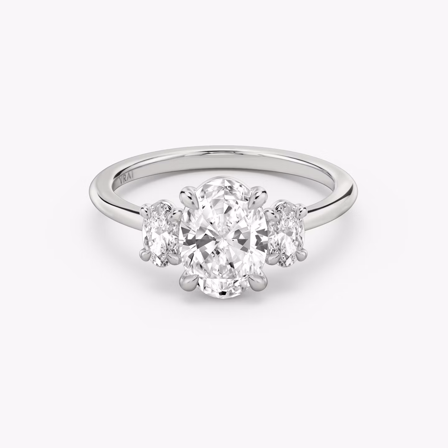 The Three Stone | Oval | 18k | White Gold | bandAccent: Plain | sideStoneCarat: 0.25ct | sideStoneShape: Oval | diamondOrientation: vertical | caratWeight: other