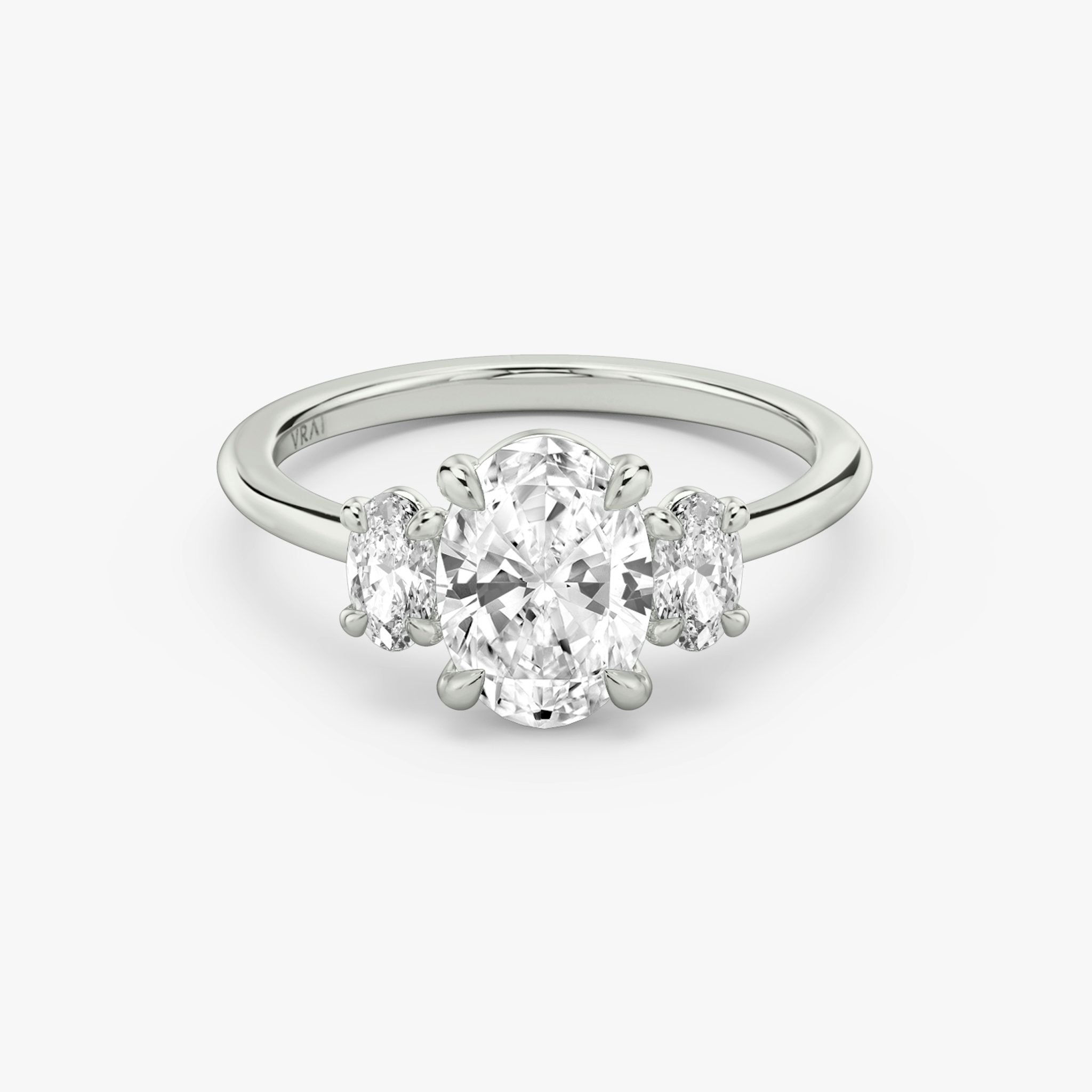 The Three Stone | Oval | 18k | White Gold | bandAccent: Plain | sideStoneCarat: 0.25ct | sideStoneShape: Oval | diamondOrientation: vertical | caratWeight: other