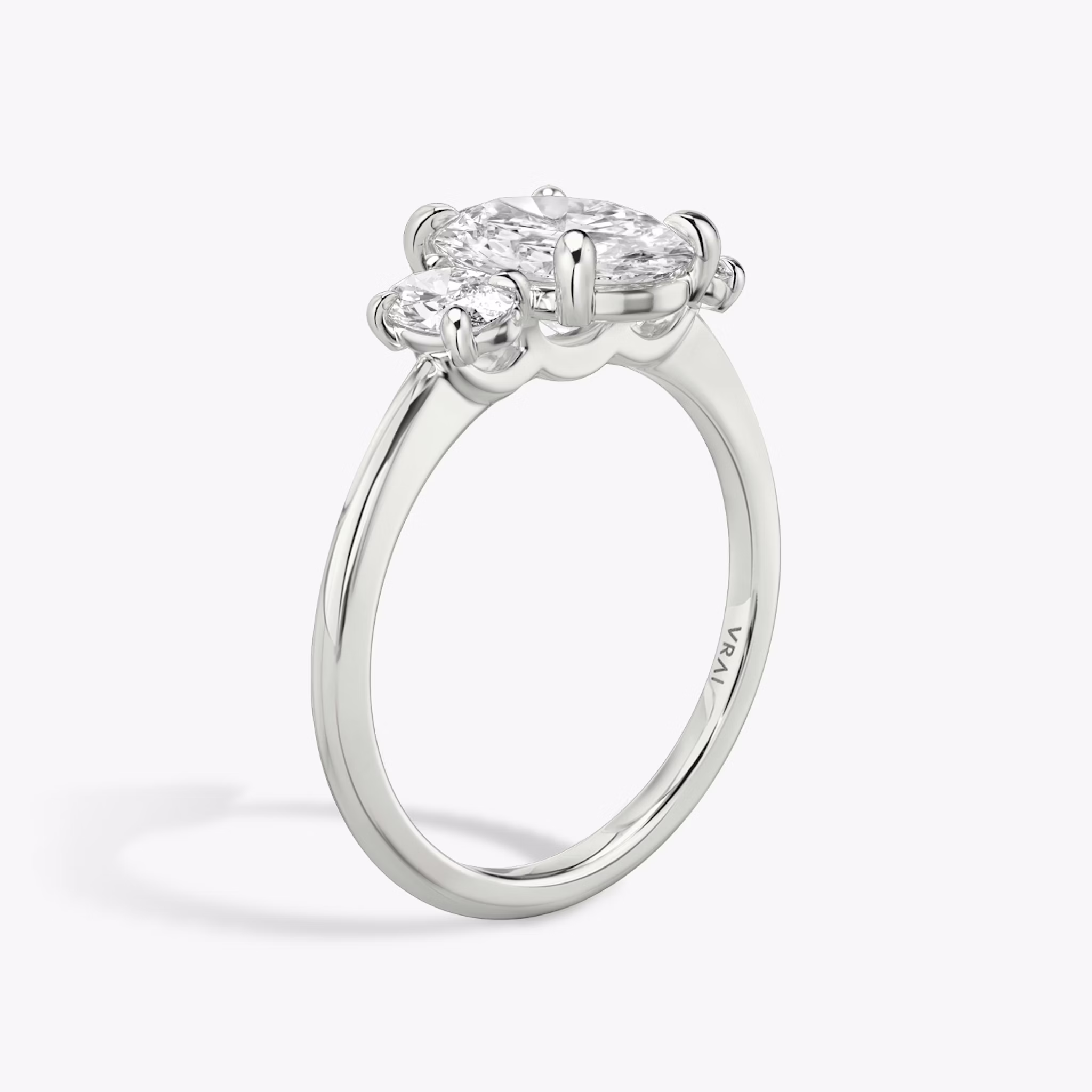 The Three Stone | Oval | Platinum | bandAccent: Plain | sideStoneCarat: 0.25ct | sideStoneShape: Oval | diamondOrientation: vertical | caratWeight: other