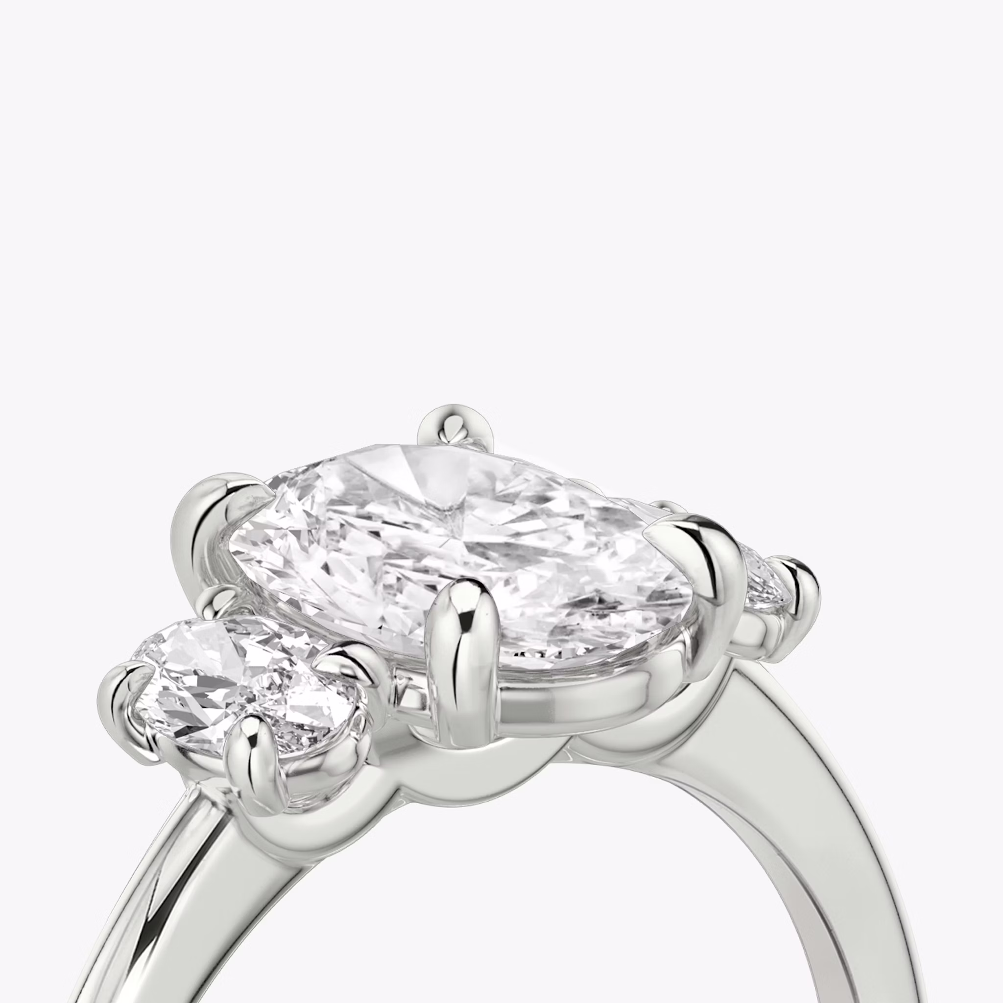 The Three Stone | Oval | 18k | White Gold | bandAccent: Plain | sideStoneCarat: 0.25ct | sideStoneShape: Oval | diamondOrientation: vertical | caratWeight: other