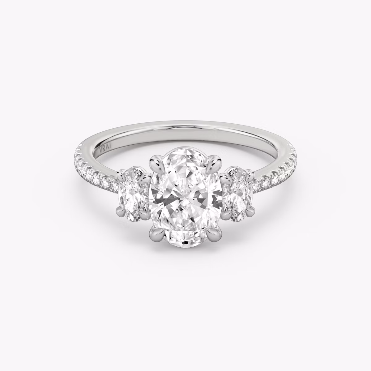 The Three Stone | Oval | 18k | White Gold | bandAccent: Pavé | sideStoneCarat: 0.25ct | sideStoneShape: Oval | diamondOrientation: vertical | caratWeight: other