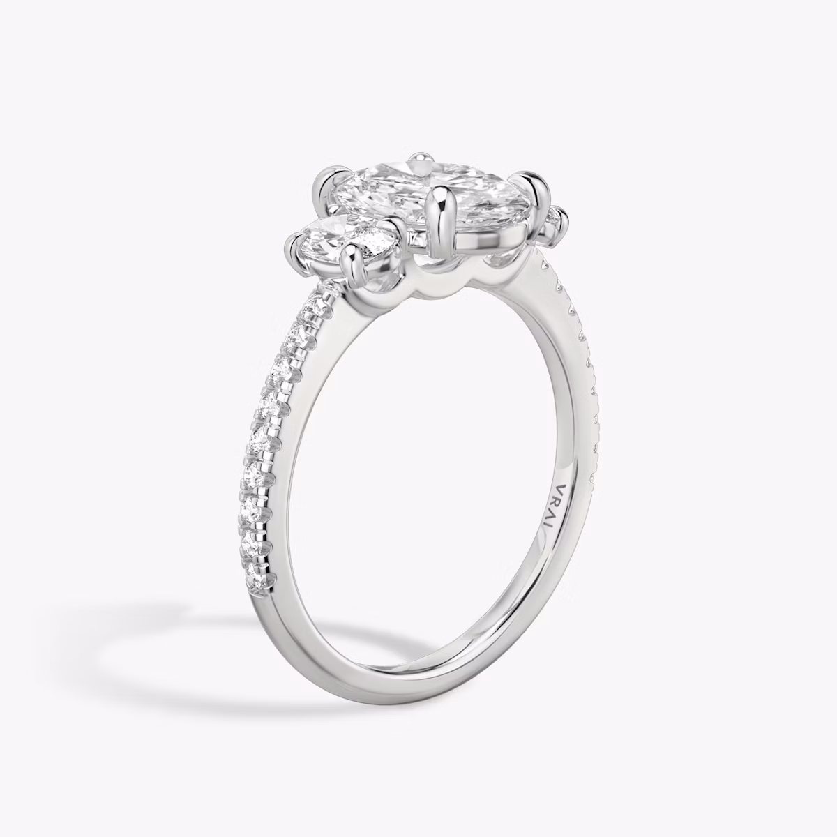The Three Stone | Oval | 18k | White Gold | bandAccent: Pavé | sideStoneCarat: 0.25ct | sideStoneShape: Oval | diamondOrientation: vertical | caratWeight: other
