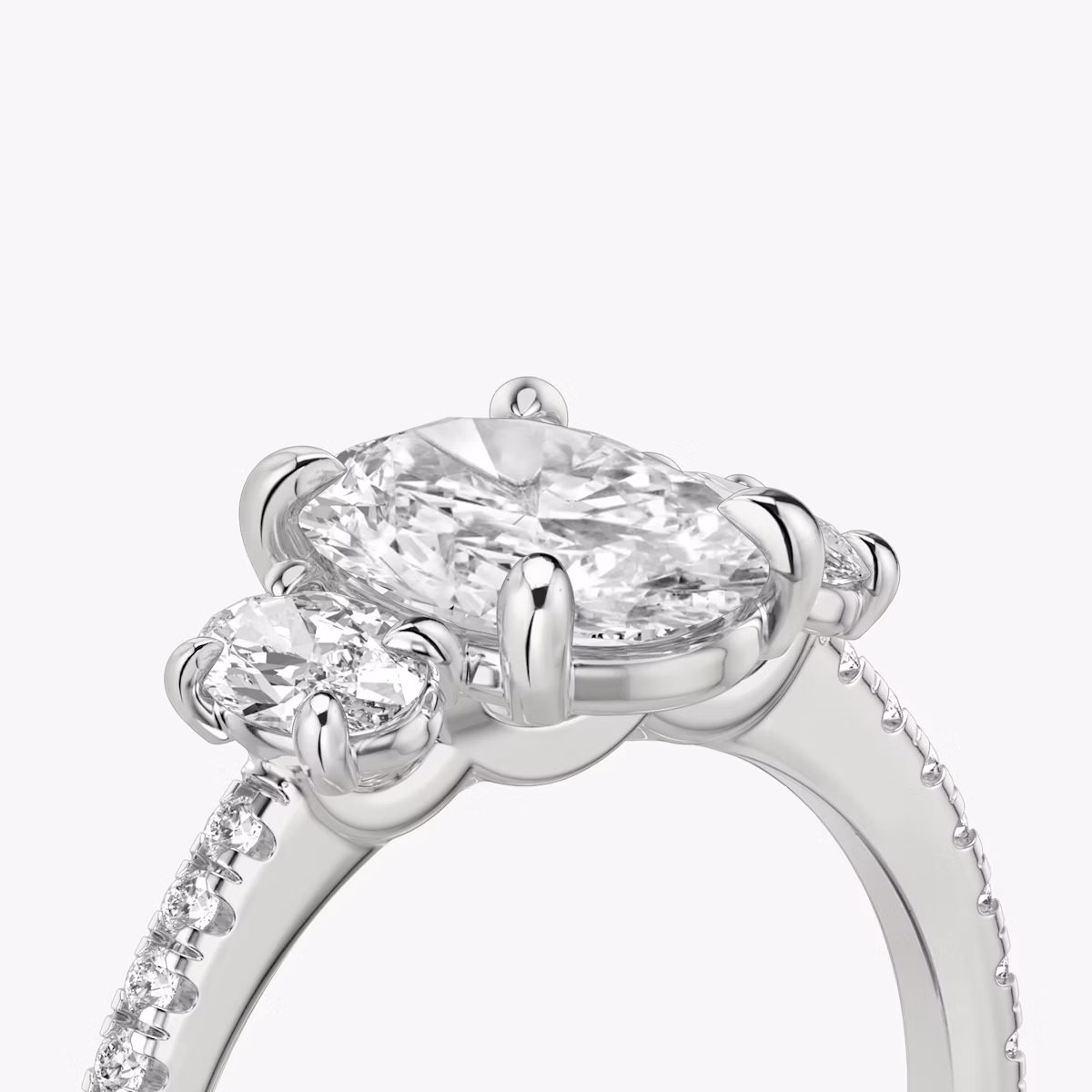The Three Stone | Oval | 18k | White Gold | bandAccent: Pavé | sideStoneCarat: 0.25ct | sideStoneShape: Oval | diamondOrientation: vertical | caratWeight: other