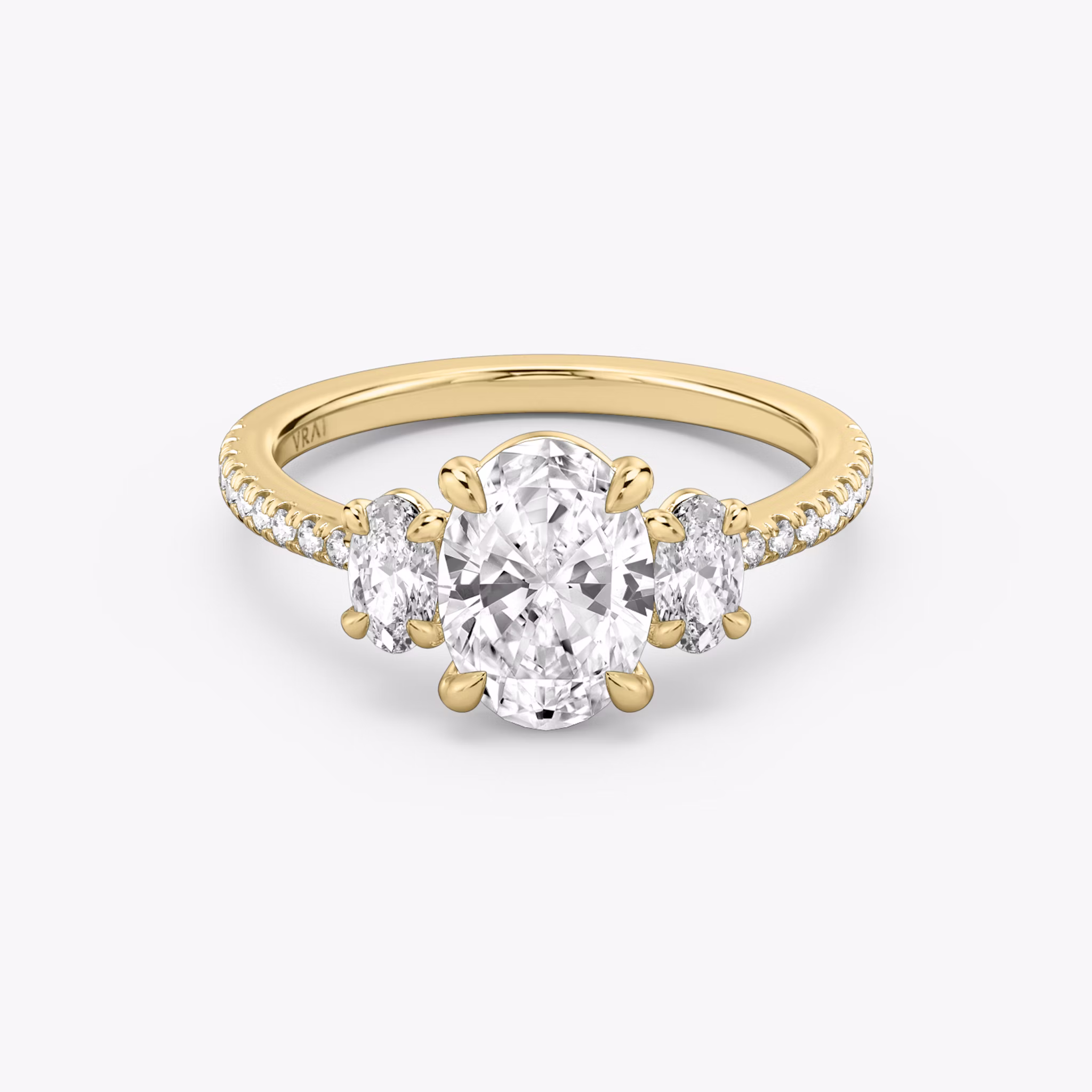The Three Stone | Oval | 18k | Yellow Gold | bandAccent: Pavé | sideStoneCarat: 0.25ct | sideStoneShape: Oval | diamondOrientation: vertical | caratWeight: other