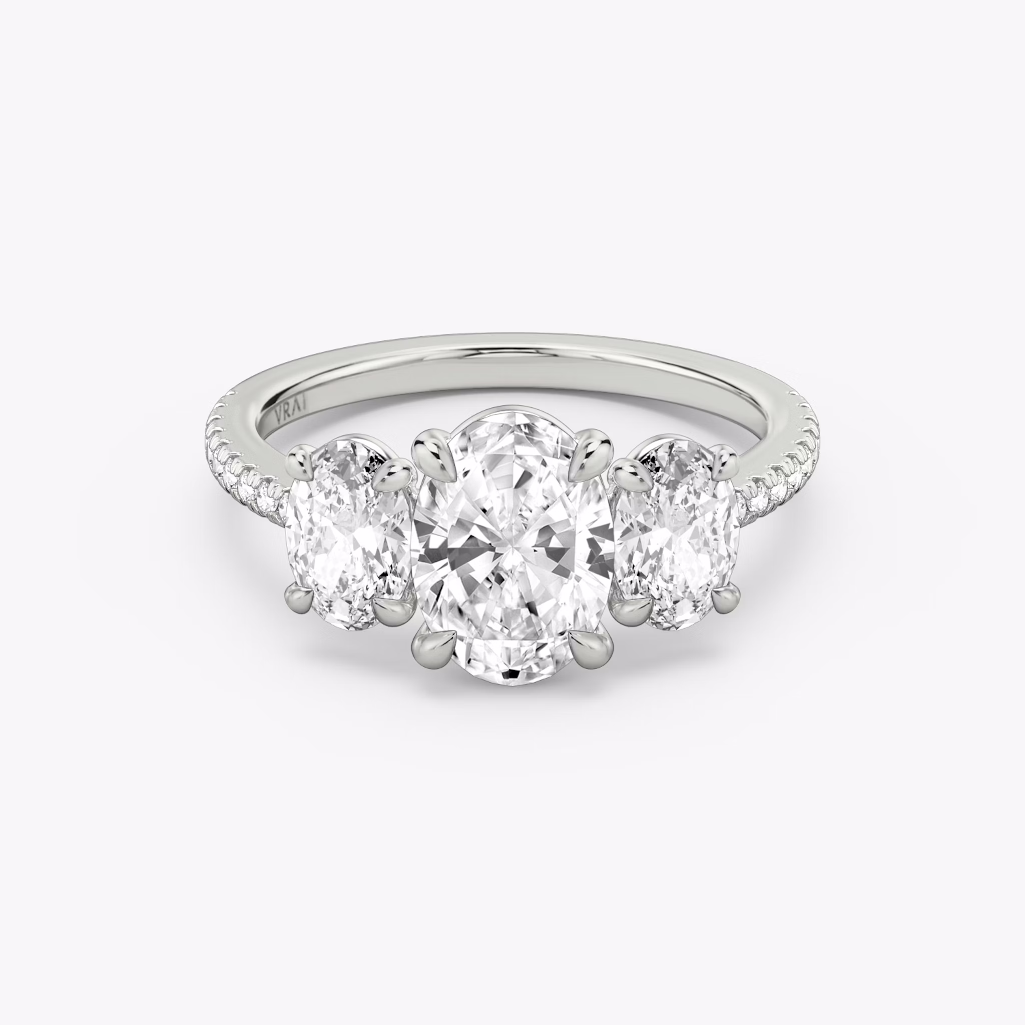 The Three Stone | Oval | 18k | White Gold | bandAccent: Pavé | sideStoneCarat: 0.50ct | sideStoneShape: Oval | diamondOrientation: vertical | caratWeight: other