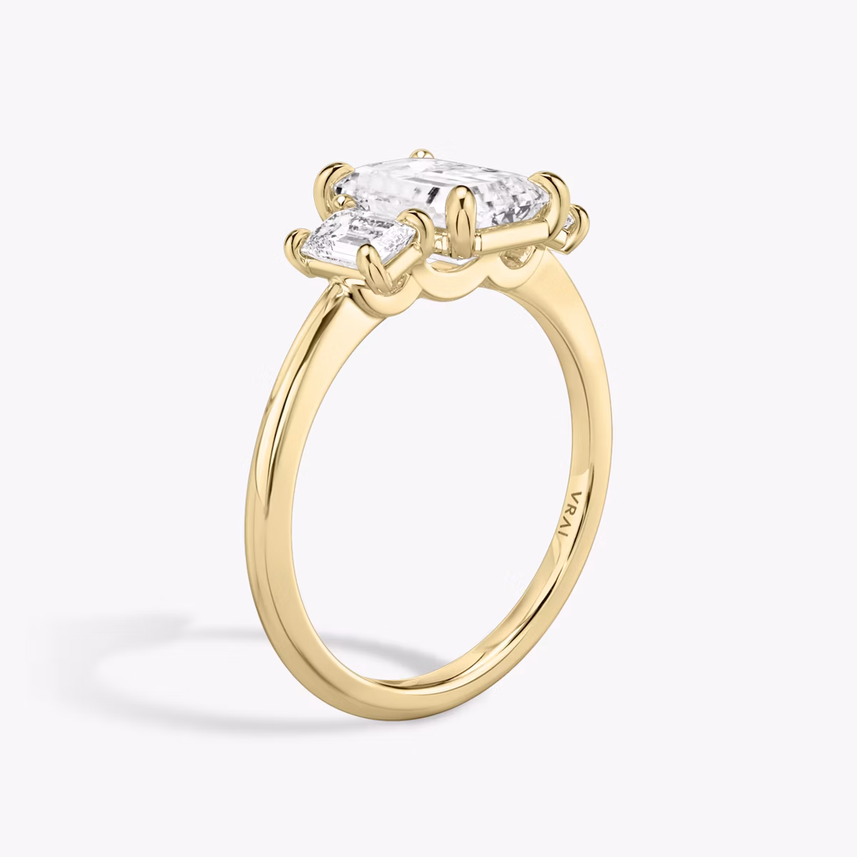 The Three Stone | Emerald | 18k | Yellow Gold | bandAccent: Plain | sideStoneCarat: 0.25ct | sideStoneShape: Emerald | diamondOrientation: vertical | caratWeight: other