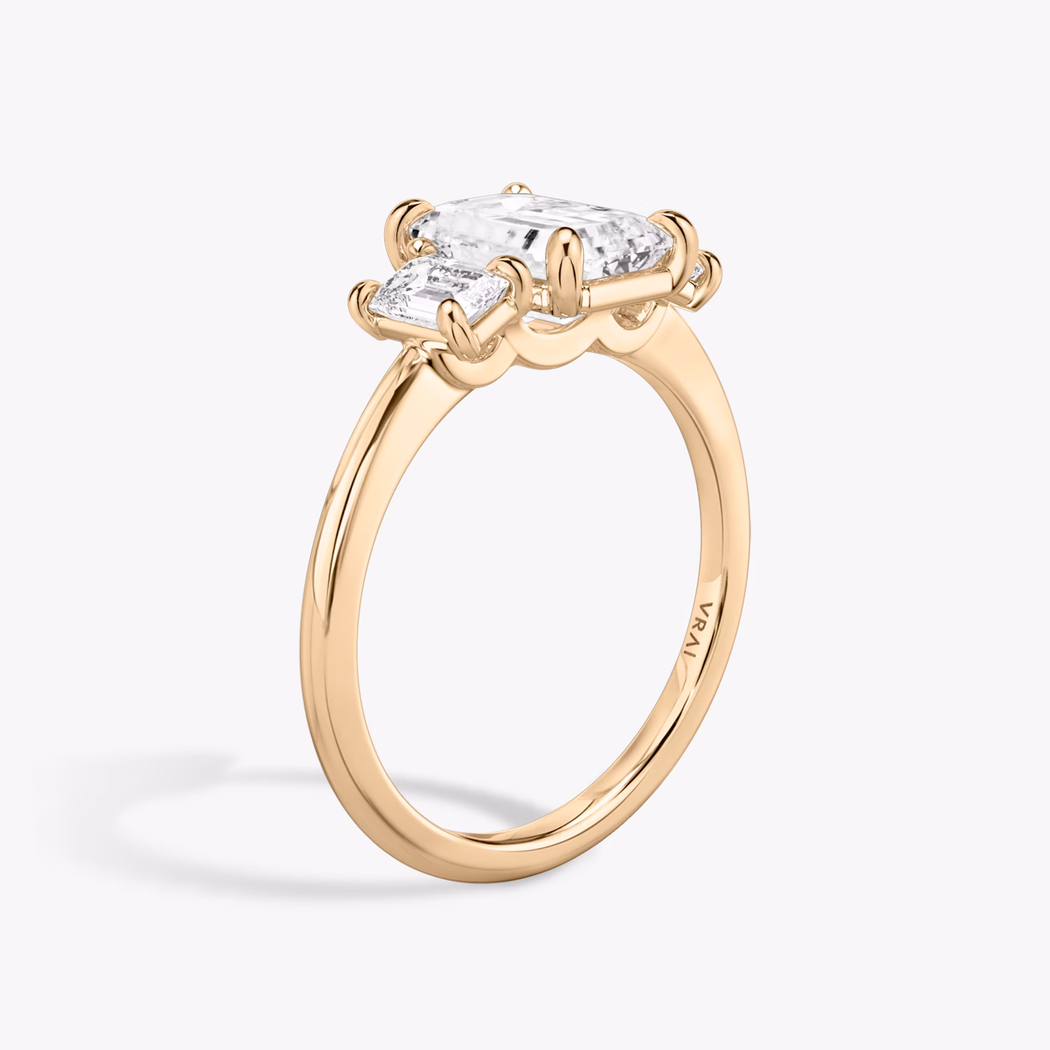The Three Stone | Emerald | 14k | Rose Gold | bandAccent: Plain | sideStoneCarat: 0.25ct | sideStoneShape: Emerald | diamondOrientation: vertical | caratWeight: other