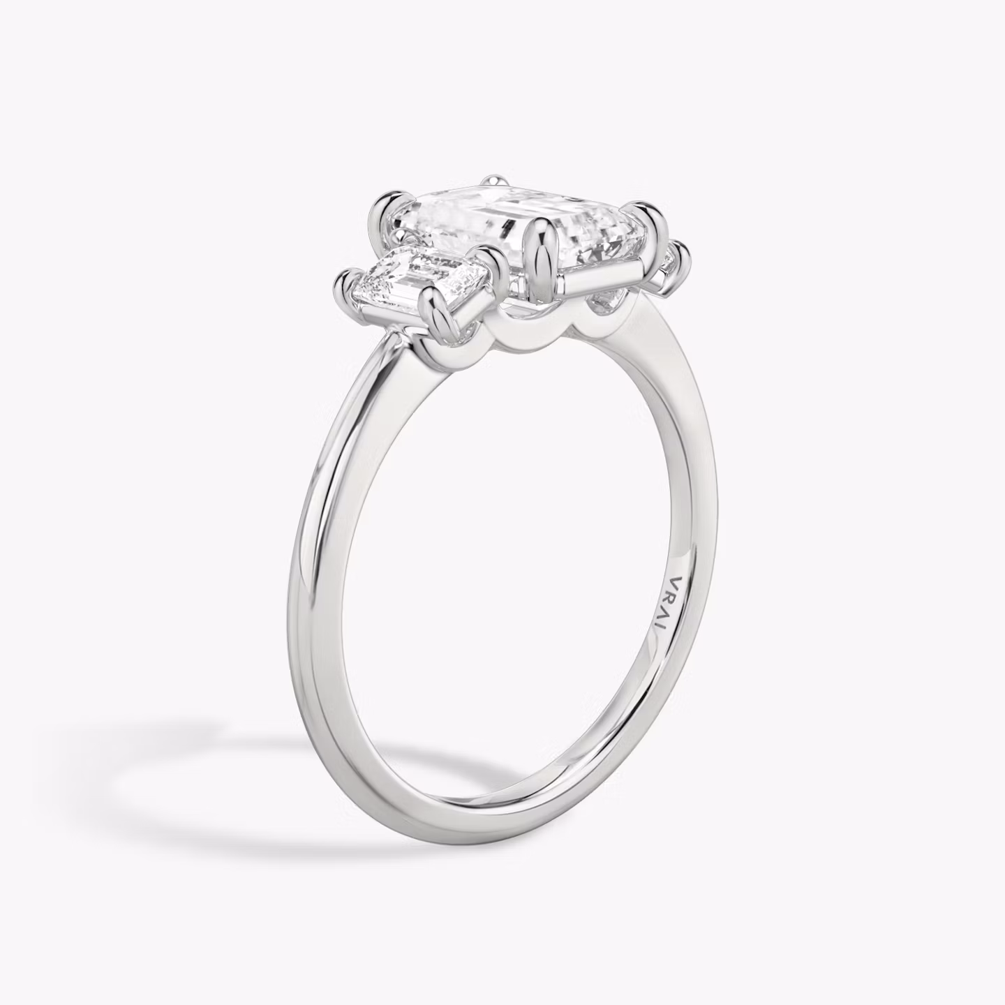 The Three Stone | Emerald | 18k | White Gold | bandAccent: Plain | sideStoneCarat: 0.25ct | sideStoneShape: Emerald | diamondOrientation: vertical | caratWeight: other