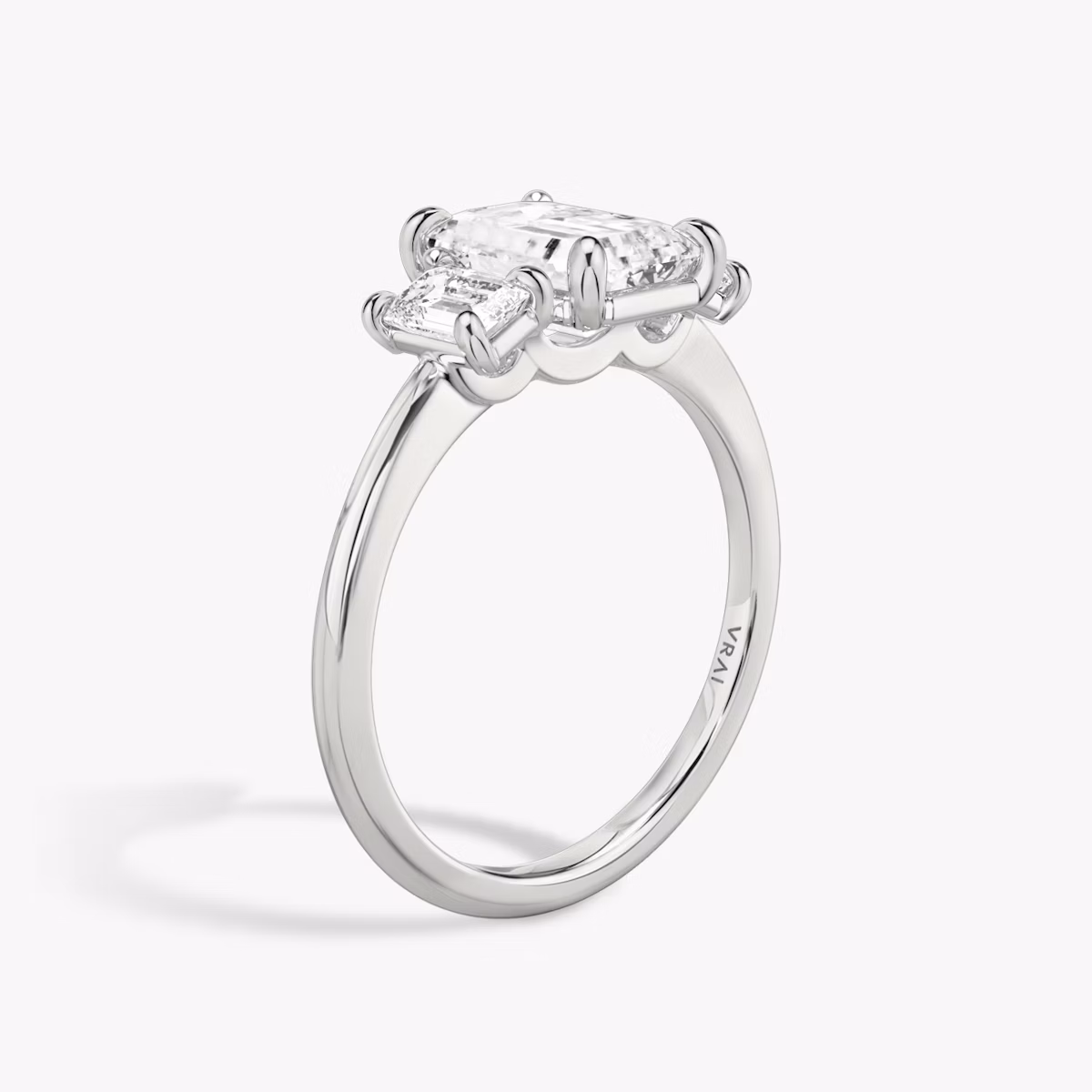 The Three Stone | Emerald | Platinum | bandAccent: Plain | sideStoneCarat: 0.25ct | sideStoneShape: Emerald | diamondOrientation: vertical | caratWeight: other