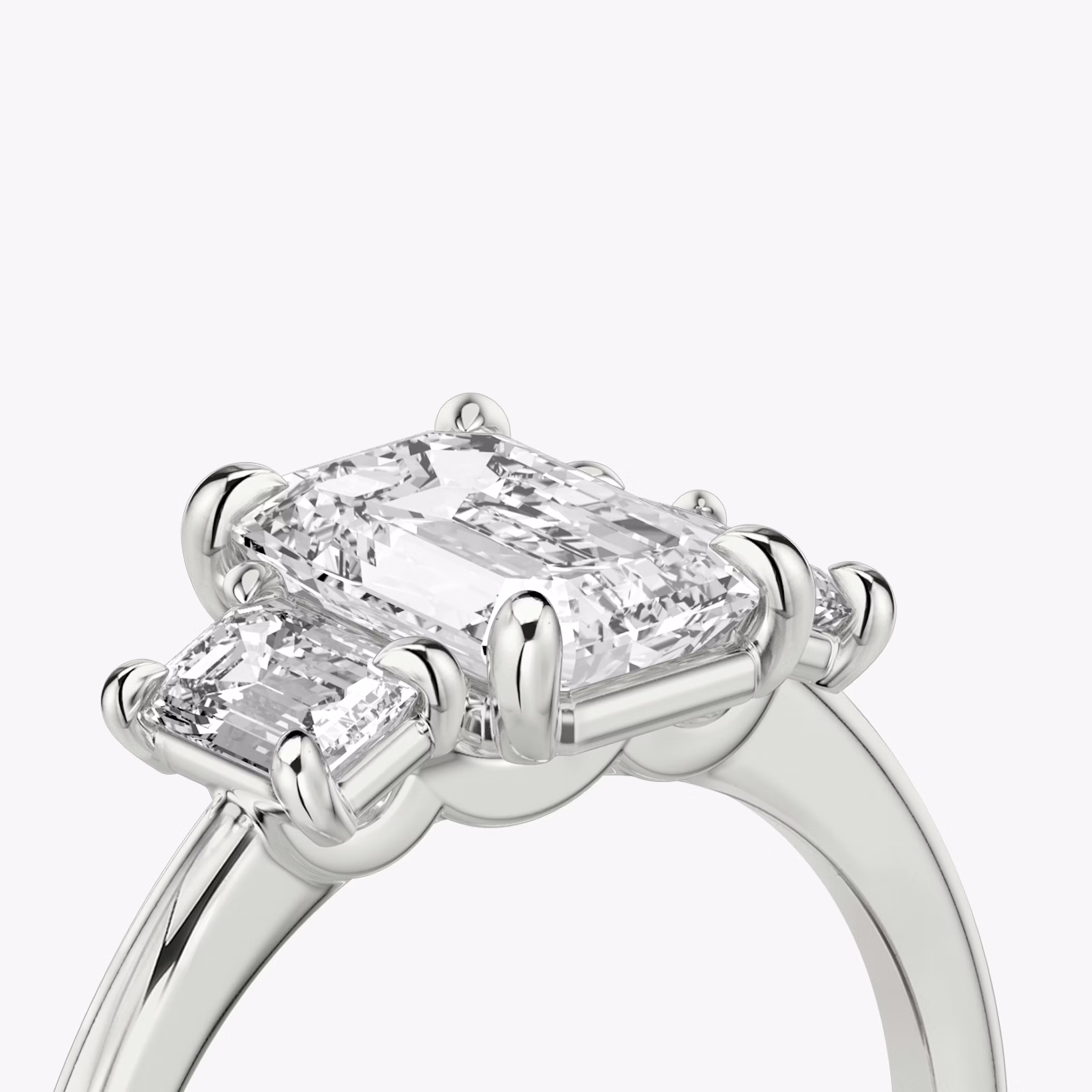 The Three Stone | Emerald | Platinum | bandAccent: Plain | sideStoneCarat: 0.25ct | sideStoneShape: Emerald | diamondOrientation: vertical | caratWeight: other