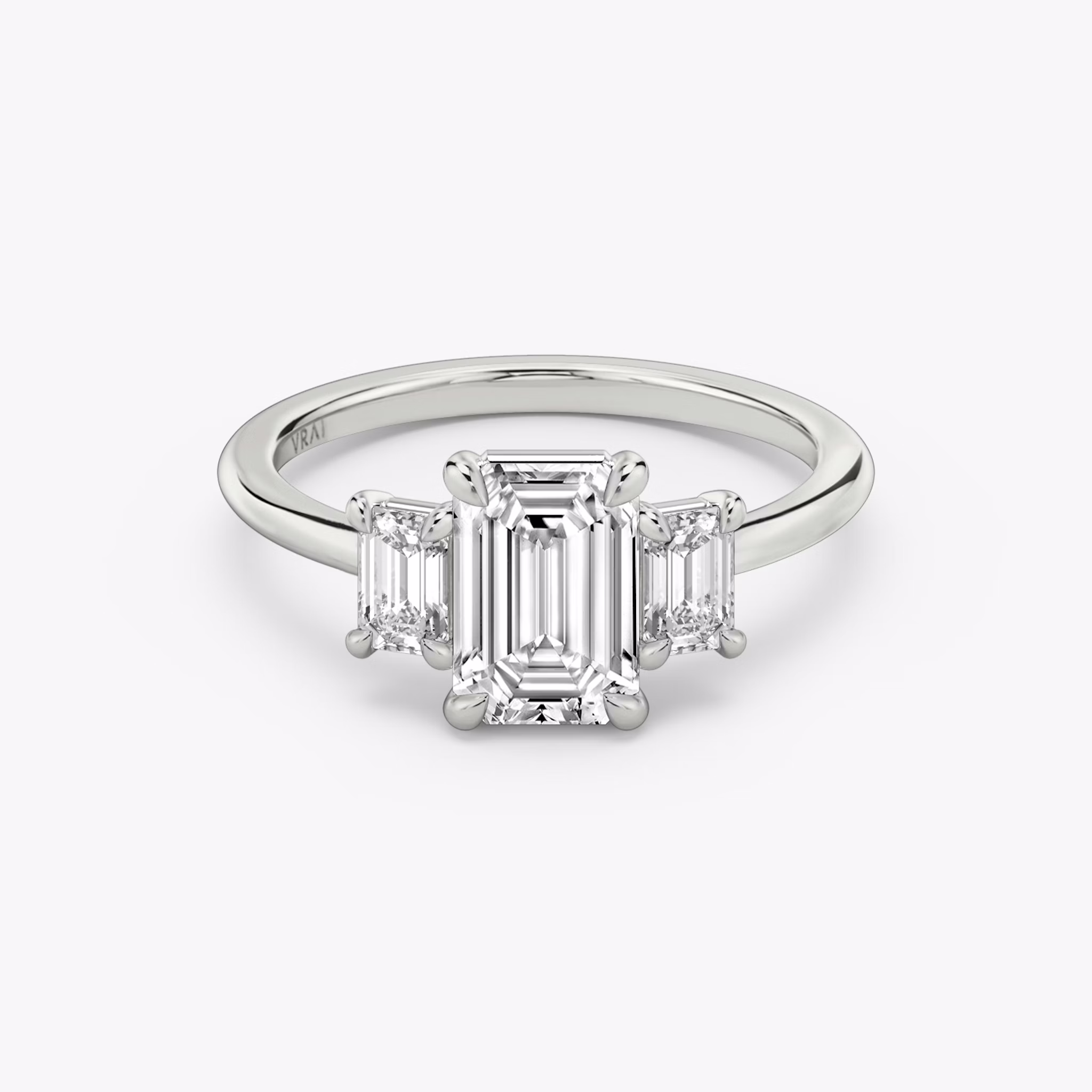The Three Stone | Emerald | Platinum | bandAccent: Plain | sideStoneCarat: 0.25ct | sideStoneShape: Emerald | diamondOrientation: vertical | caratWeight: other