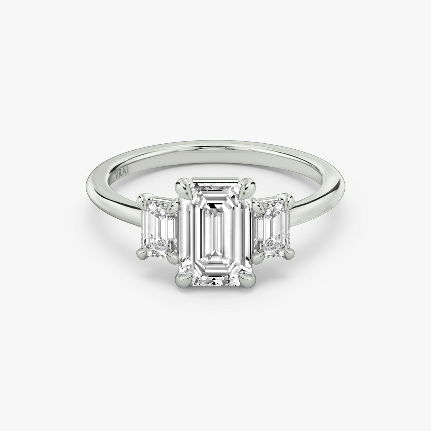 The Three Stone | Emerald | Platinum | bandAccent: Plain | sideStoneCarat: 0.25ct | sideStoneShape: Emerald | diamondOrientation: vertical | caratWeight: other