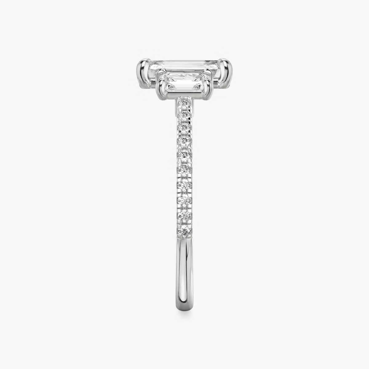 The Three Stone | Emerald | Platinum | bandAccent: Pavé | sideStoneCarat: 0.25ct | sideStoneShape: Emerald | diamondOrientation: vertical | caratWeight: other