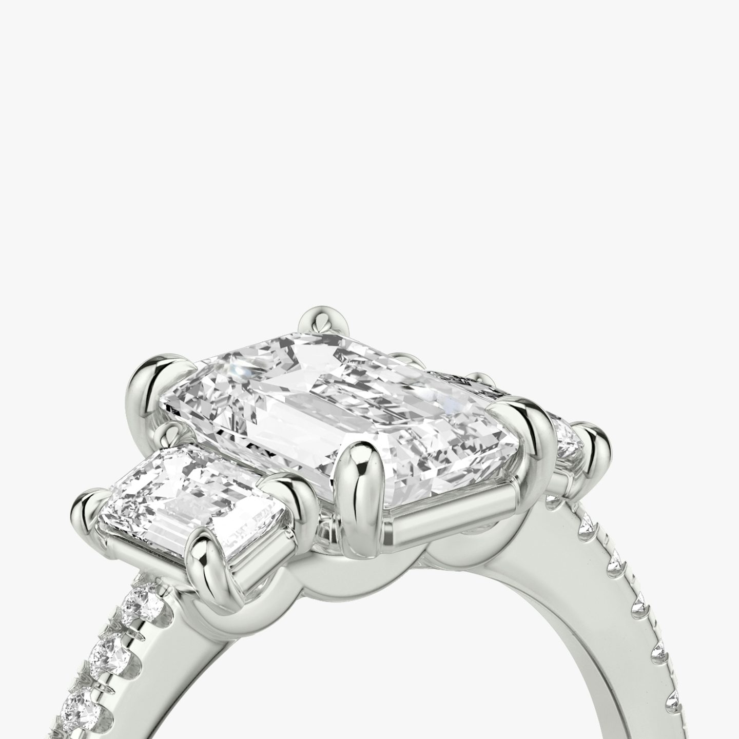 The Three Stone | Emerald | Platinum | bandAccent: Pavé | sideStoneCarat: 0.25ct | sideStoneShape: Emerald | diamondOrientation: vertical | caratWeight: other