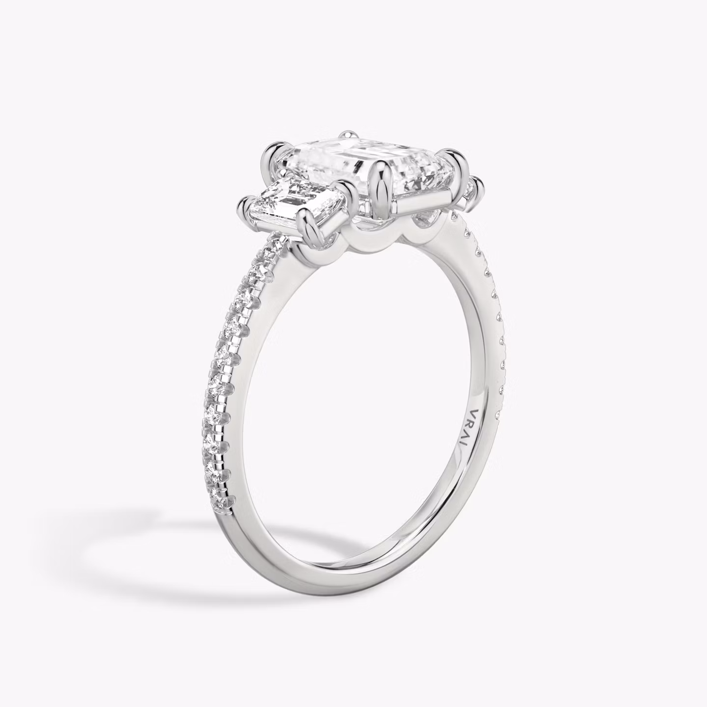 The Three Stone | Emerald | 18k | White Gold | bandAccent: Pavé | sideStoneCarat: 0.25ct | sideStoneShape: Emerald | diamondOrientation: vertical | caratWeight: other