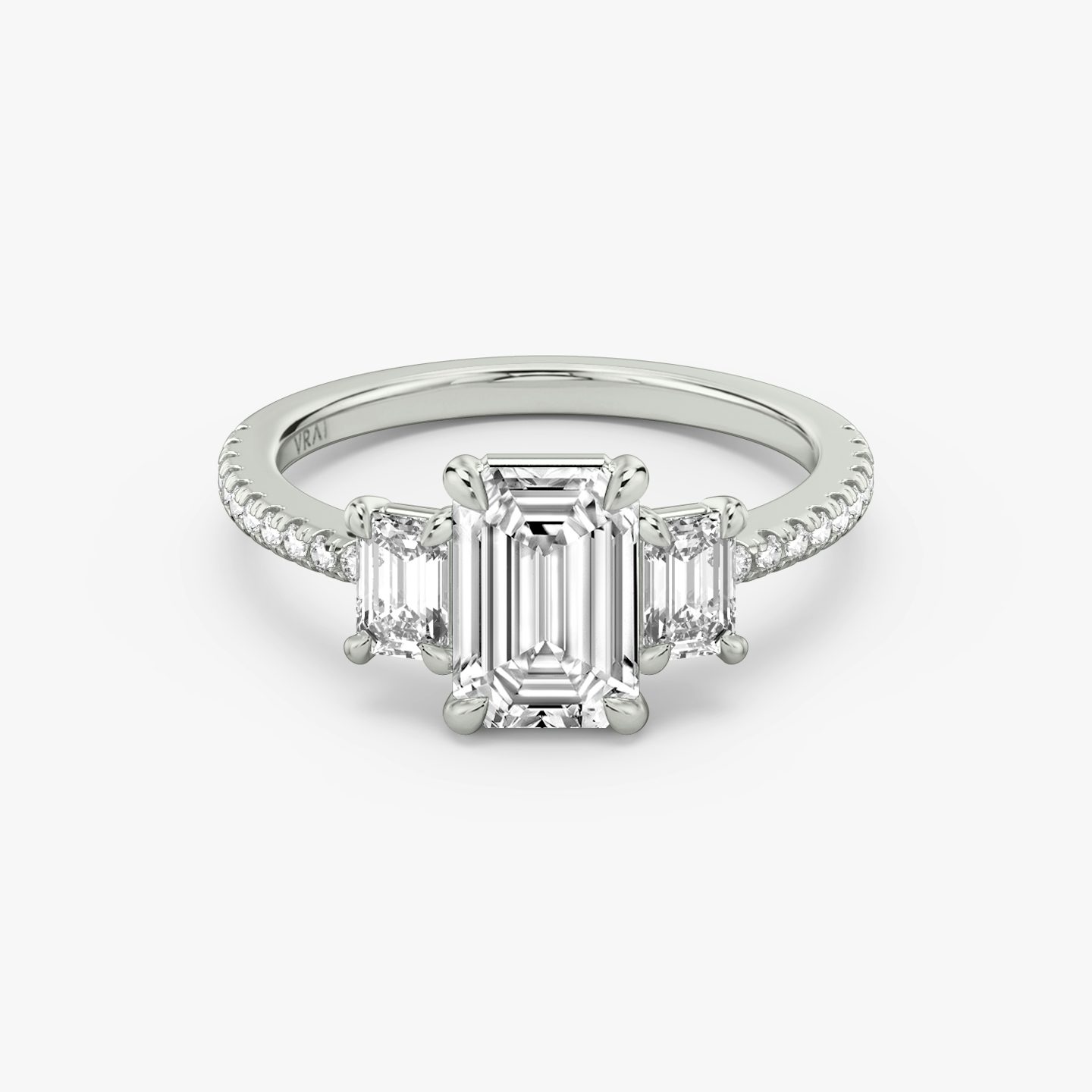 The Three Stone | Emerald | Platinum | bandAccent: Pavé | sideStoneCarat: 0.25ct | sideStoneShape: Emerald | diamondOrientation: vertical | caratWeight: other