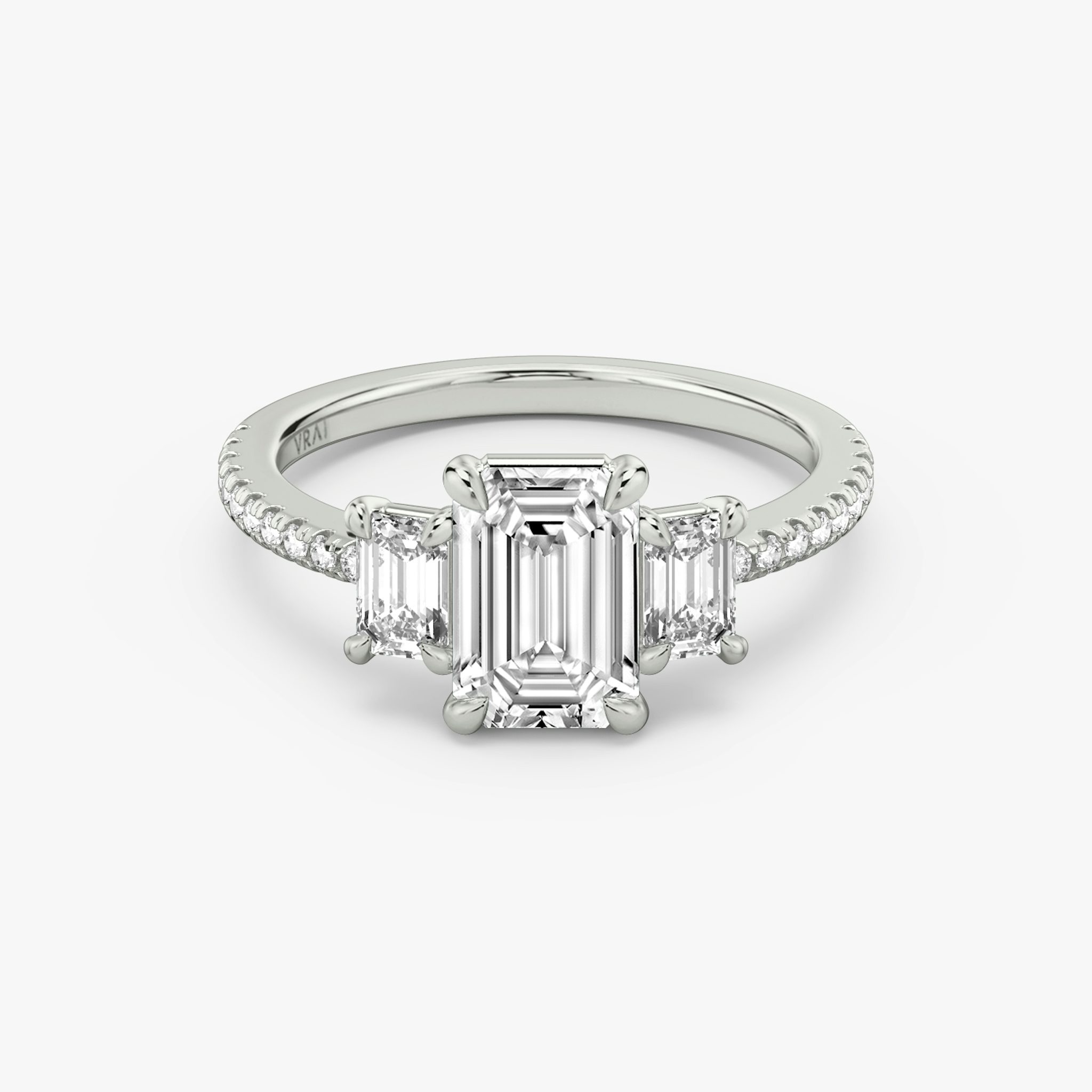 The Three Stone | Emerald | Platinum | bandAccent: Pavé | sideStoneCarat: 0.25ct | sideStoneShape: Emerald | diamondOrientation: vertical | caratWeight: other