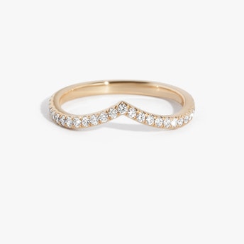Rose gold pavé dip band with curved design and small round diamonds, displayed on white background.