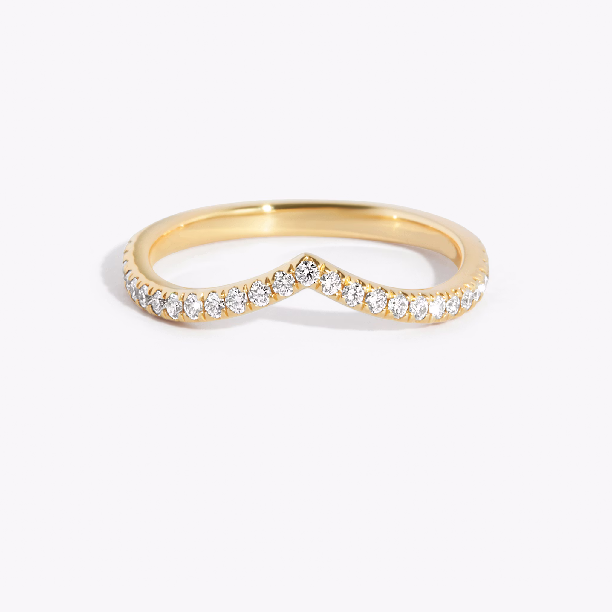 Dip band ring with pavé-set stones, crafted in yellow gold with a faux finish, shown on white background.