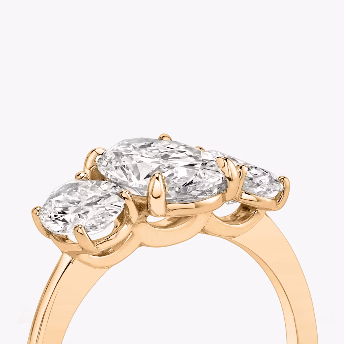 The Three Stone | Oval | 14k | Rose Gold | bandAccent: Plain | sideStoneCarat: 0.50ct | sideStoneShape: Oval | diamondOrientation: vertical | caratWeight: other