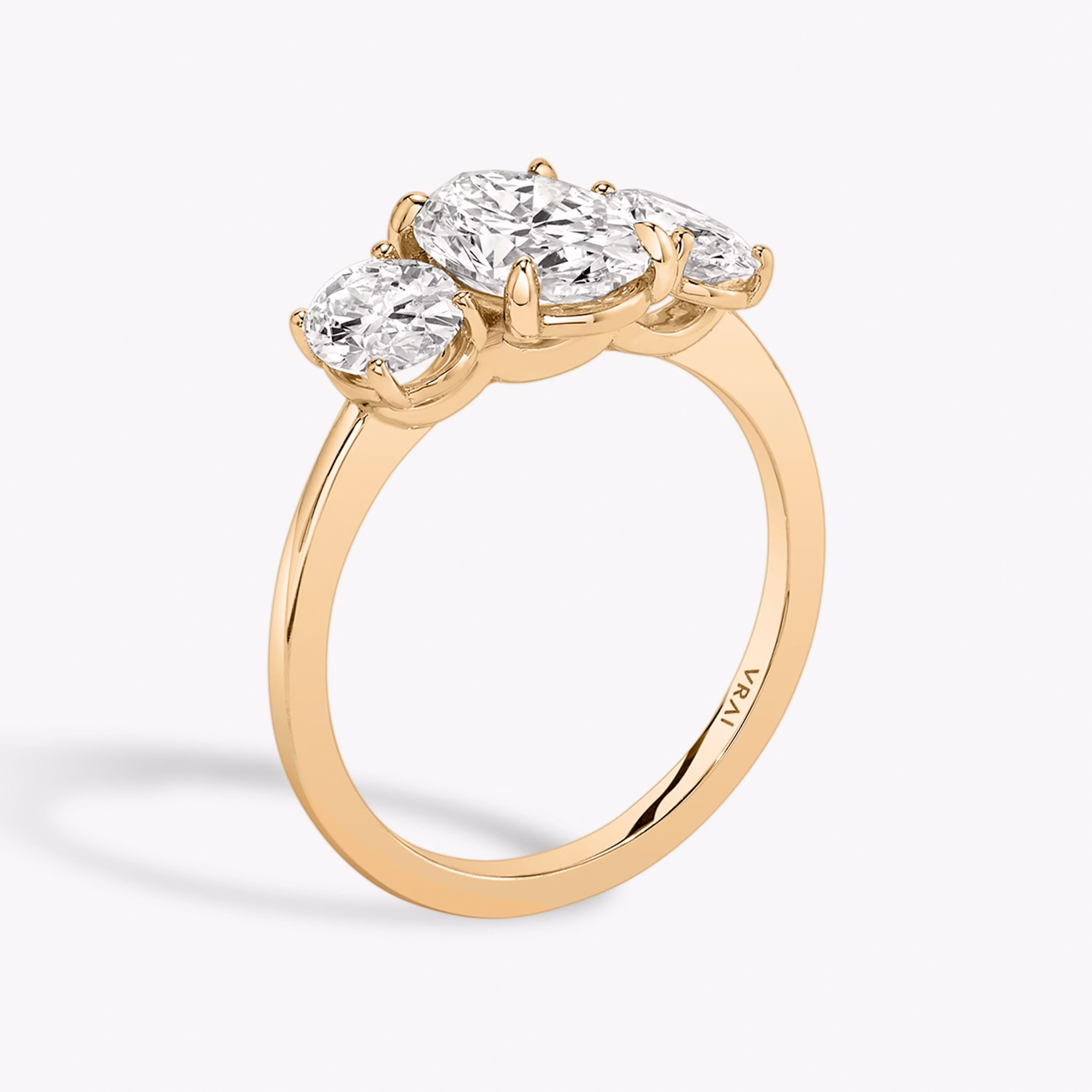 The Three Stone | Oval | 14k | Rose Gold | bandAccent: Plain | sideStoneCarat: 0.50ct | sideStoneShape: Oval | diamondOrientation: vertical | caratWeight: other