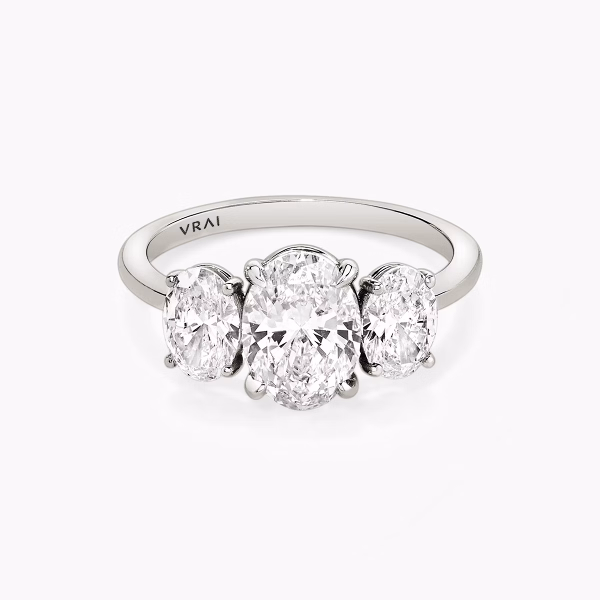 The Three Stone | Oval | Platinum | bandAccent: Plain | sideStoneCarat: 0.50ct | sideStoneShape: Oval | diamondOrientation: vertical | caratWeight: other