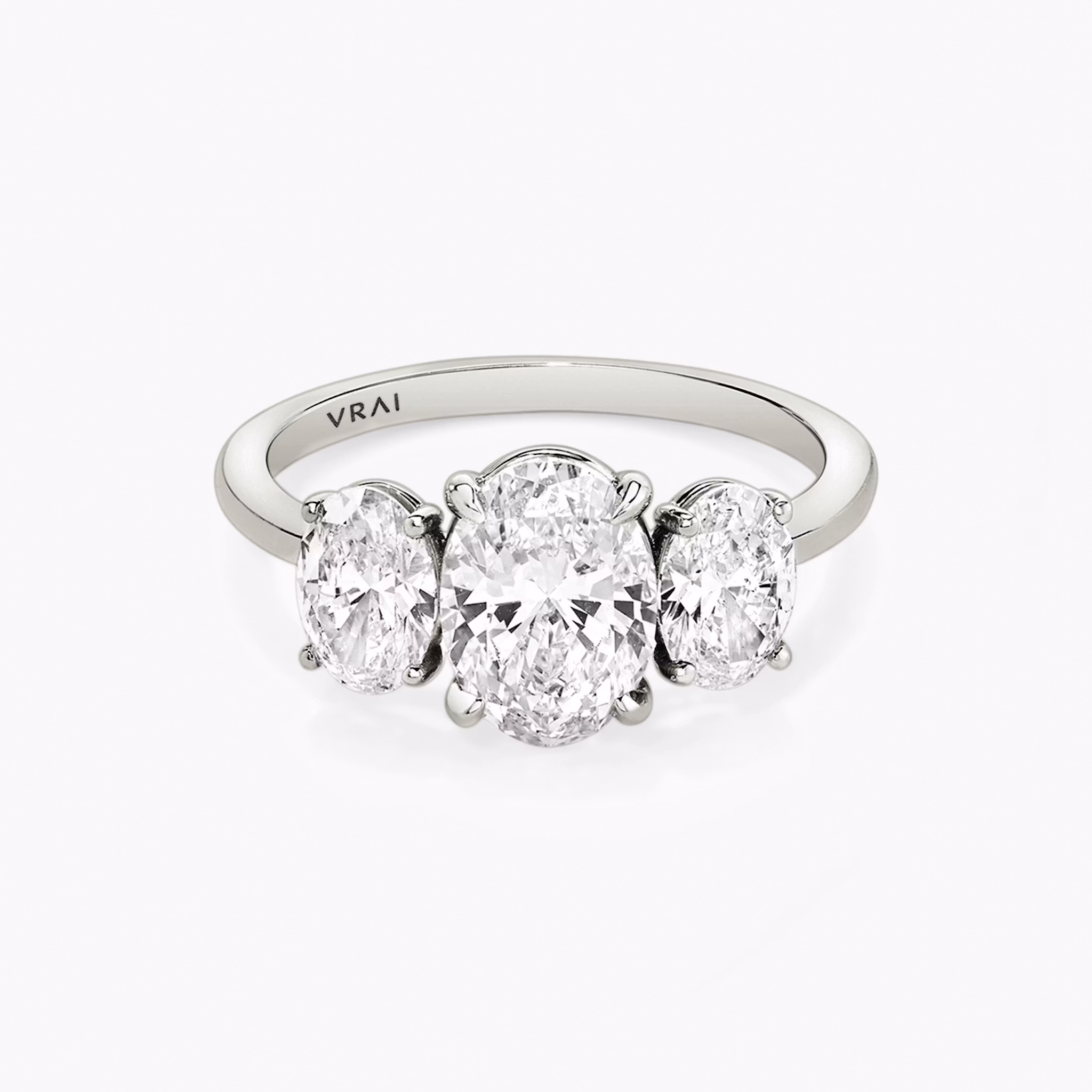 The Three Stone | Oval | 18k | White Gold | bandAccent: Plain | sideStoneCarat: 0.50ct | sideStoneShape: Oval | diamondOrientation: vertical | caratWeight: other