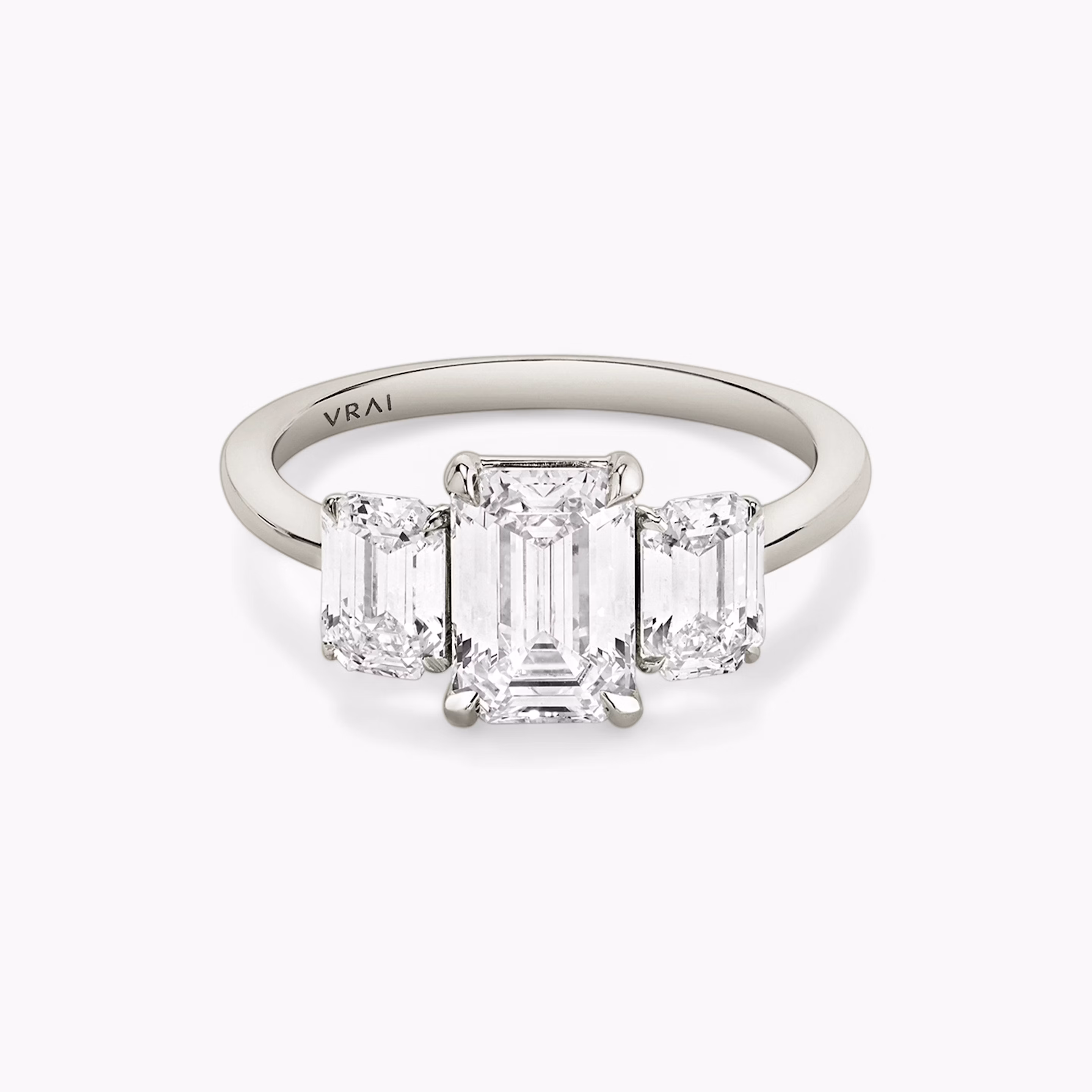 platinum three stone emerald engagement ring