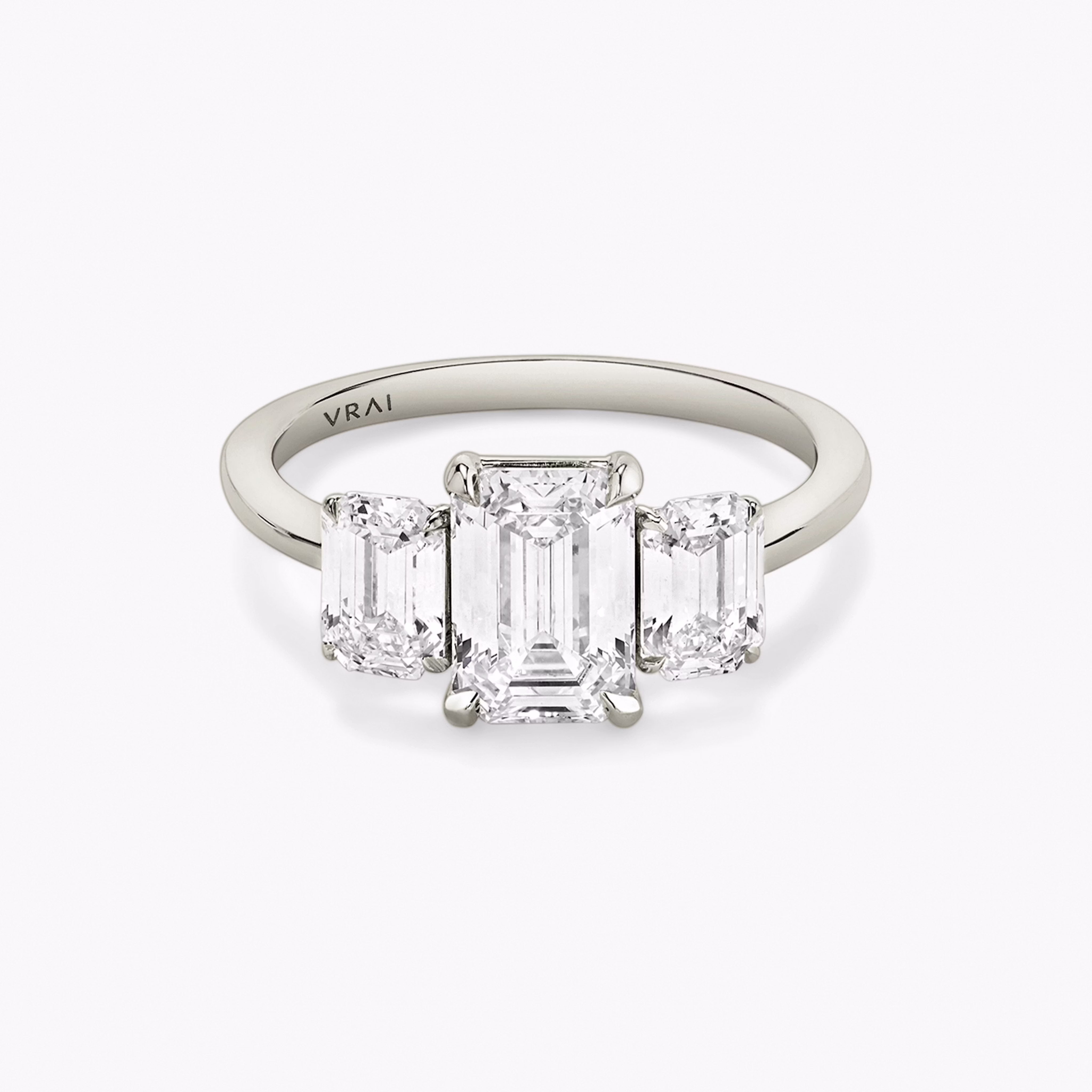platinum three stone emerald engagement ring