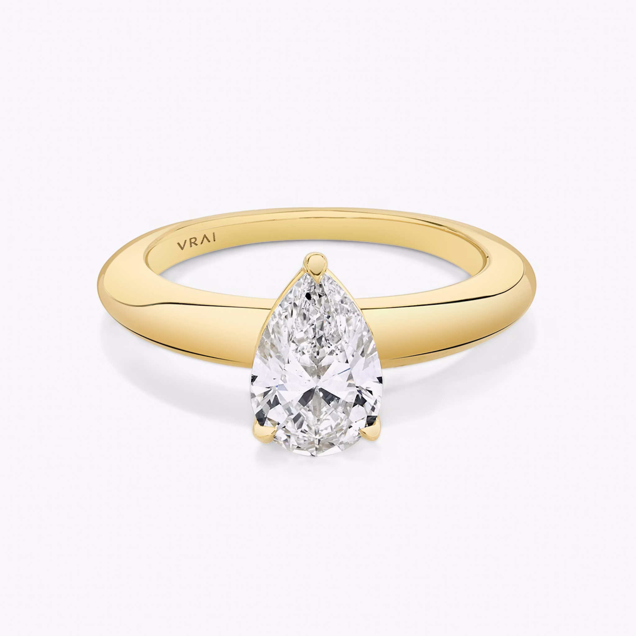 Front view of the curator pear yellow gold engagement ring