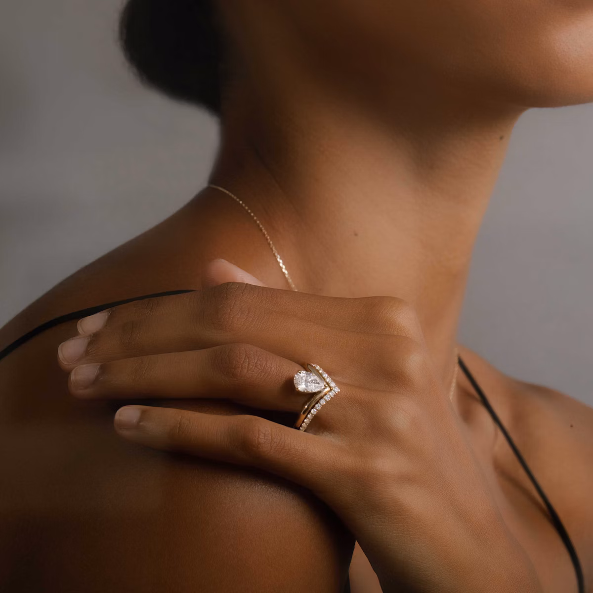 Model wearing pear cut engagement ring