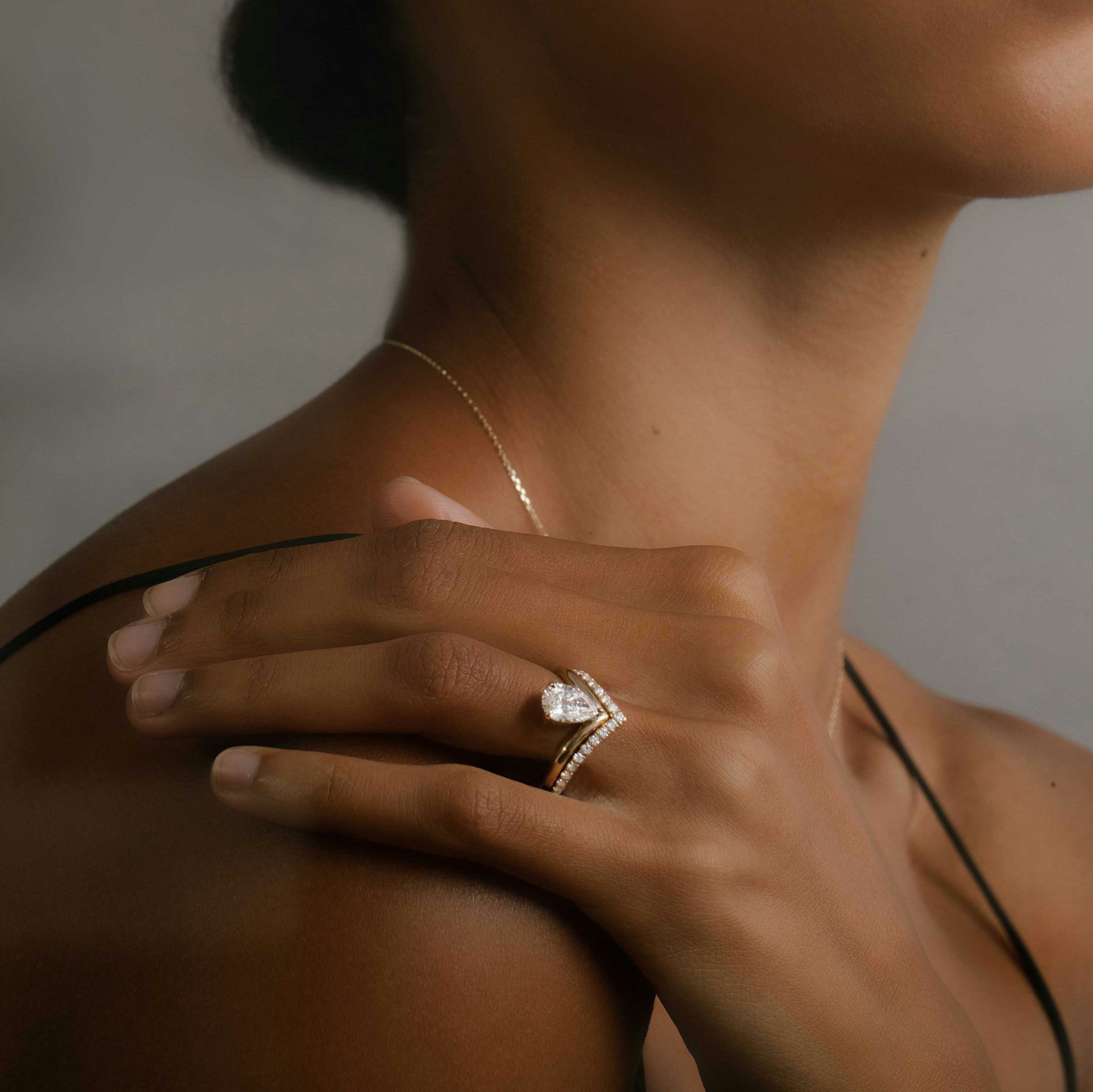 Model wearing pear cut engagement ring