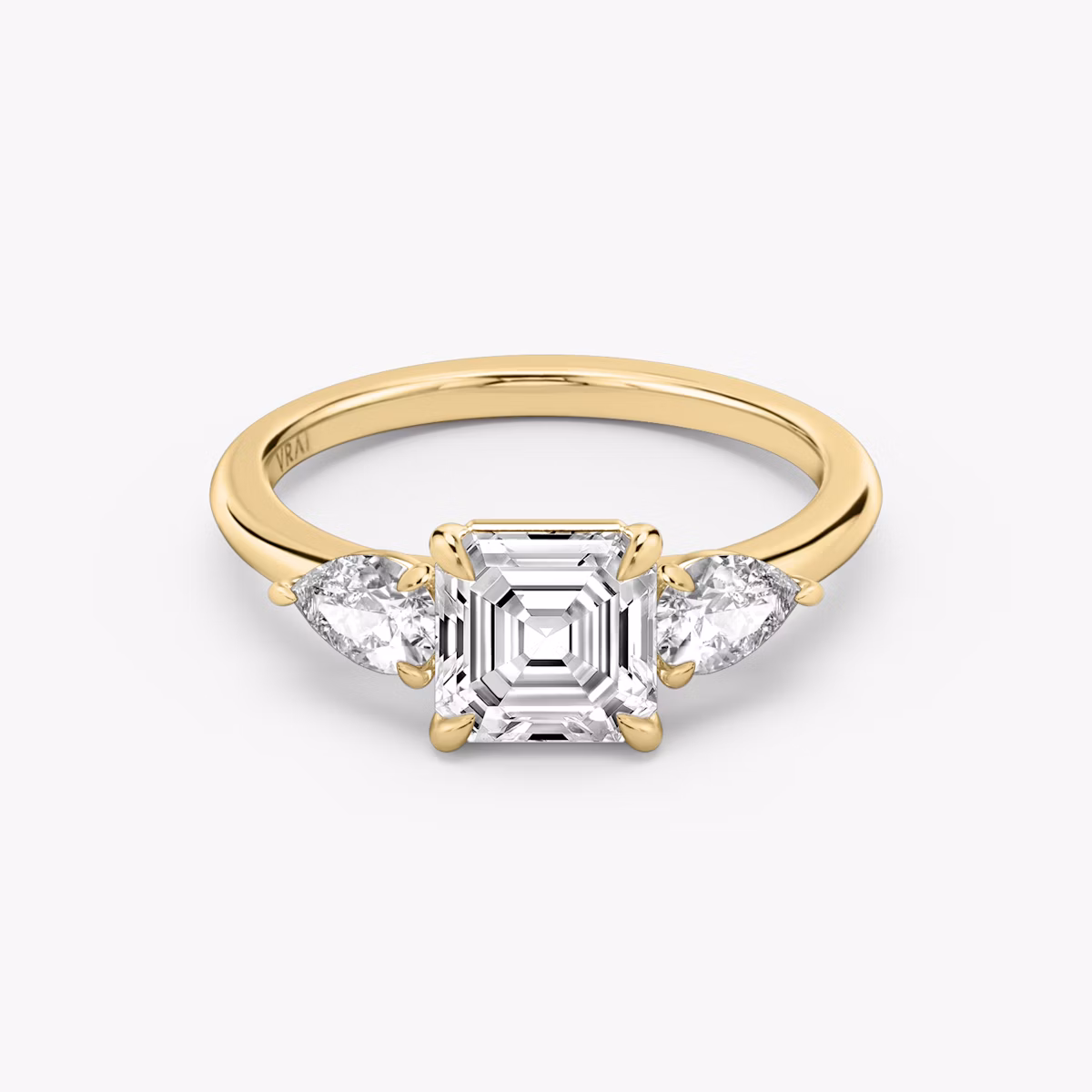 The Three Stone | Asscher | 18k | Yellow Gold | bandAccent: Plain | sideStoneCarat: 0.25ct | sideStoneShape: Pear | diamondOrientation: vertical | caratWeight: other