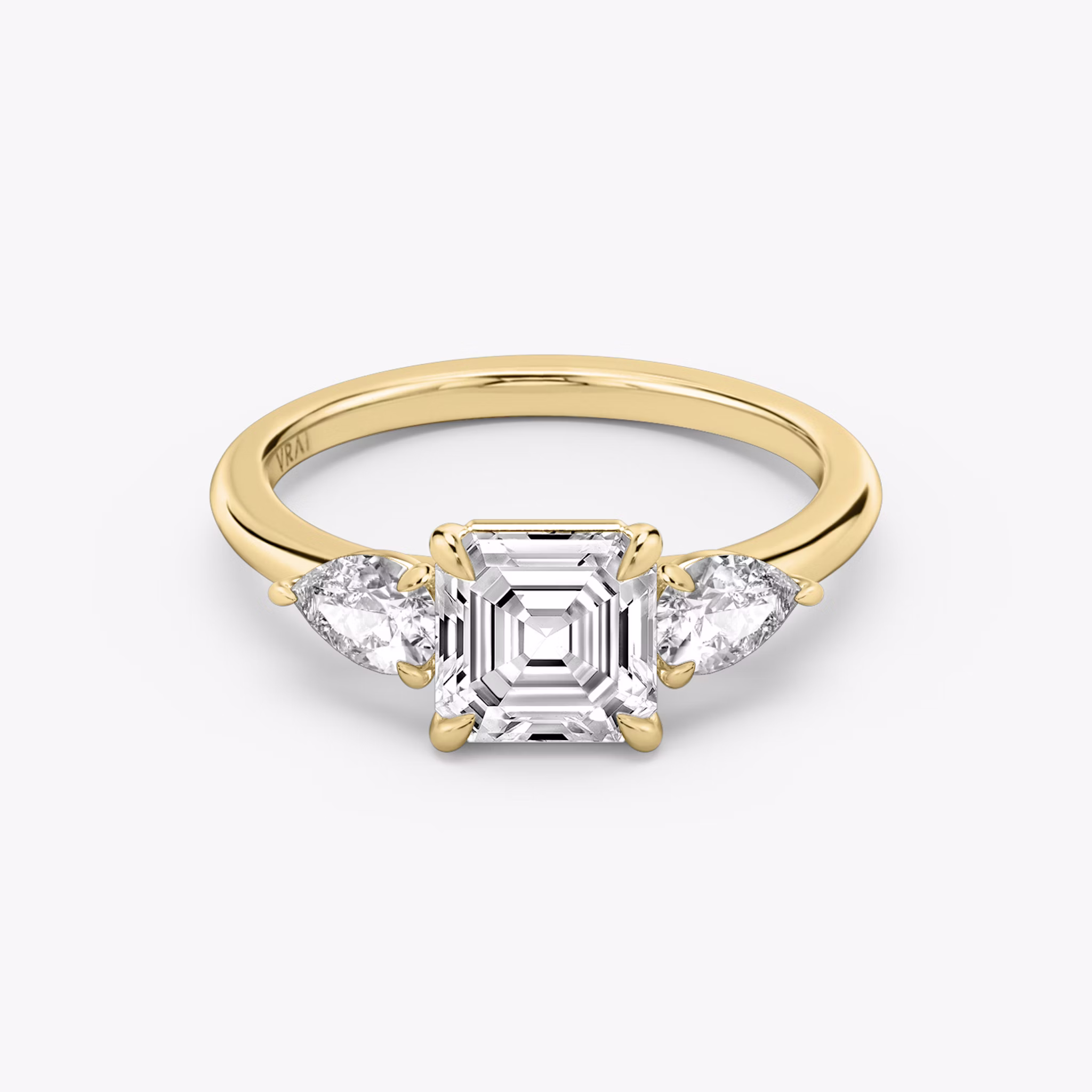 The Three Stone | Asscher | 18k | Yellow Gold | bandAccent: Plain | sideStoneCarat: 0.25ct | sideStoneShape: Pear | diamondOrientation: vertical | caratWeight: other