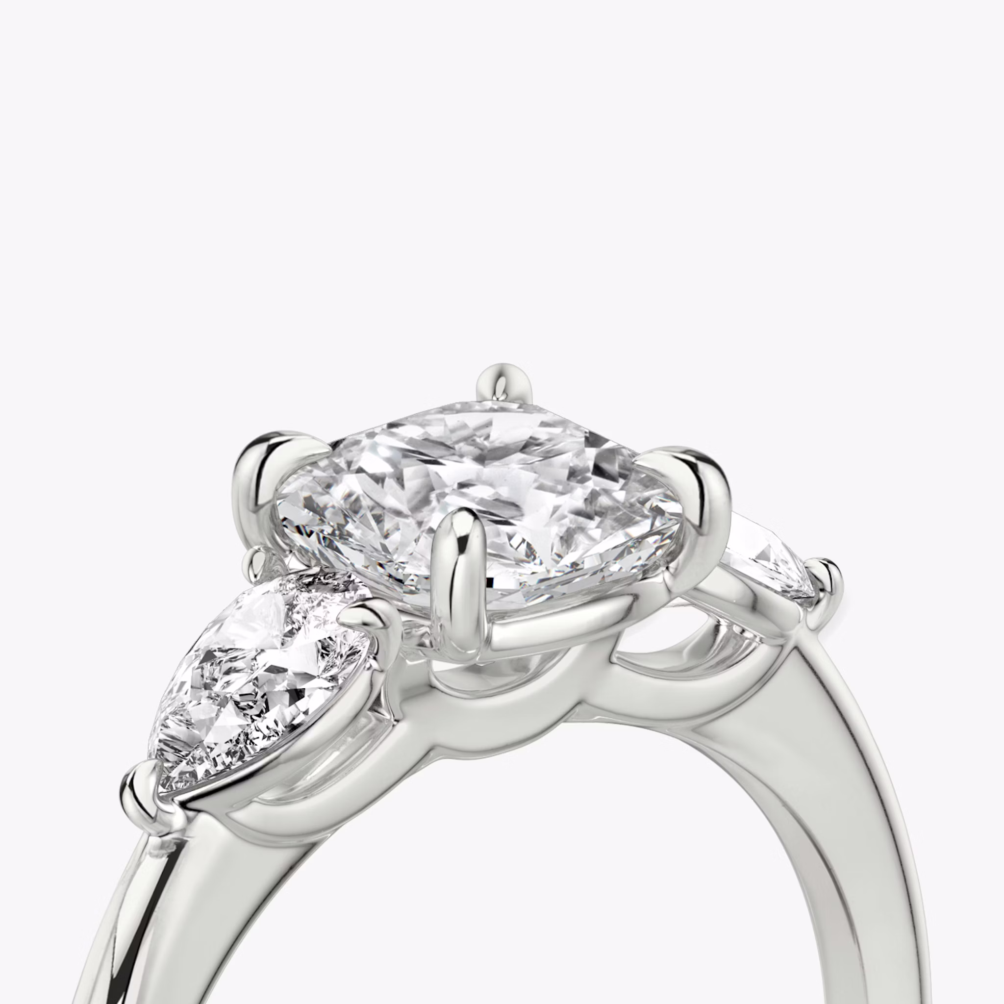 The Three Stone | Cushion | Platinum | bandAccent: Plain | sideStoneCarat: 0.25ct | sideStoneShape: Pear | diamondOrientation: vertical | caratWeight: other
