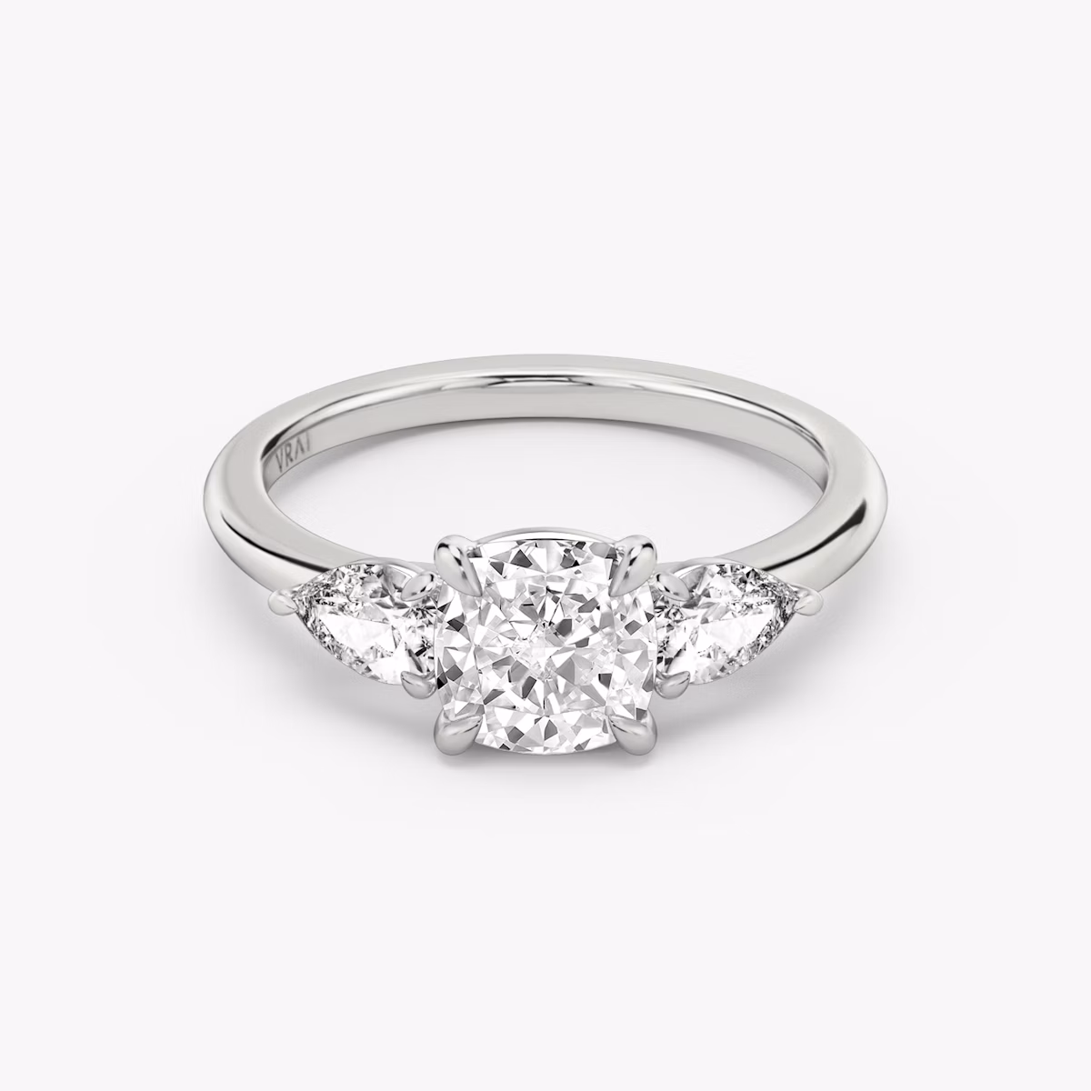 The Three Stone | Cushion | Platinum | bandAccent: Plain | sideStoneCarat: 0.25ct | sideStoneShape: Pear | diamondOrientation: vertical | caratWeight: other