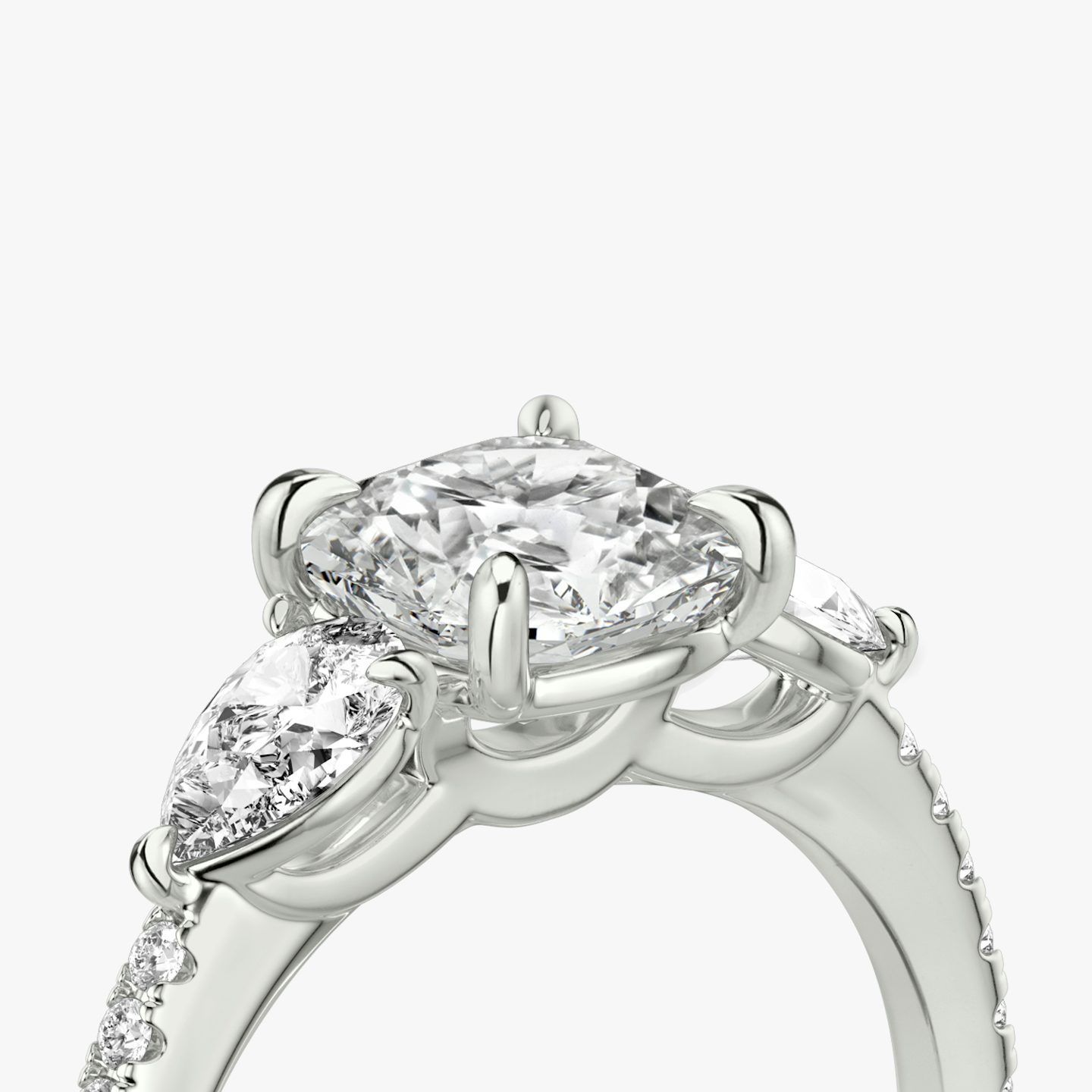 The Three Stone | Cushion | Platinum | bandAccent: Pavé | sideStoneCarat: 0.25ct | sideStoneShape: Pear | diamondOrientation: vertical | caratWeight: other
