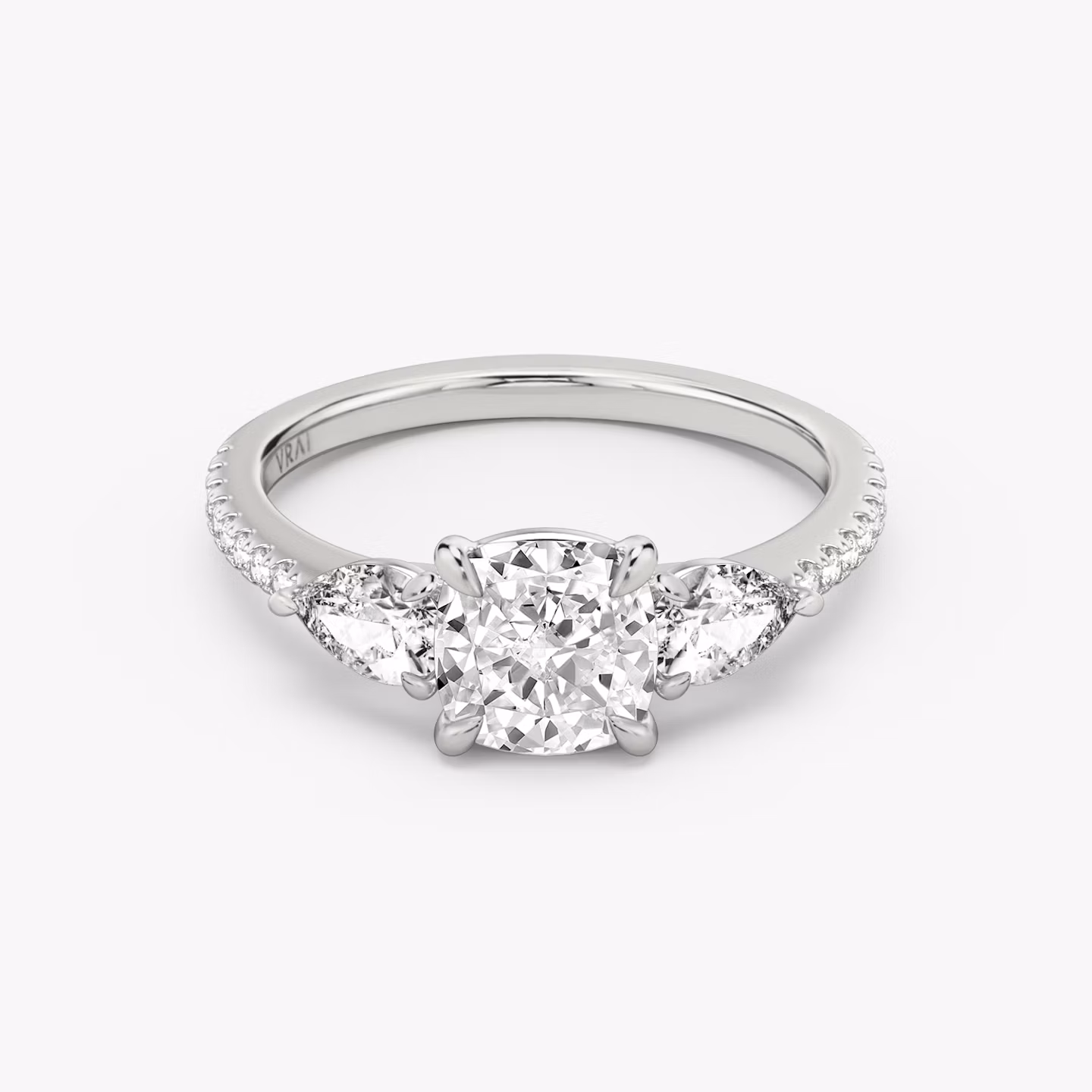 The Three Stone | Cushion | Platinum | bandAccent: Pavé | sideStoneCarat: 0.25ct | sideStoneShape: Pear | diamondOrientation: vertical | caratWeight: other
