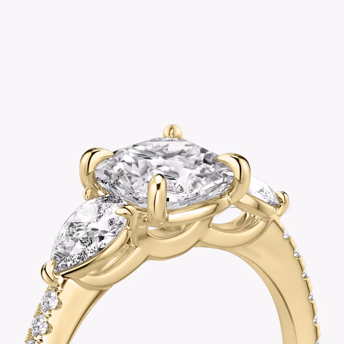 The Three Stone | Cushion | 18k | Yellow Gold | bandAccent: Pavé | sideStoneCarat: 0.25ct | sideStoneShape: Pear | diamondOrientation: vertical | caratWeight: other