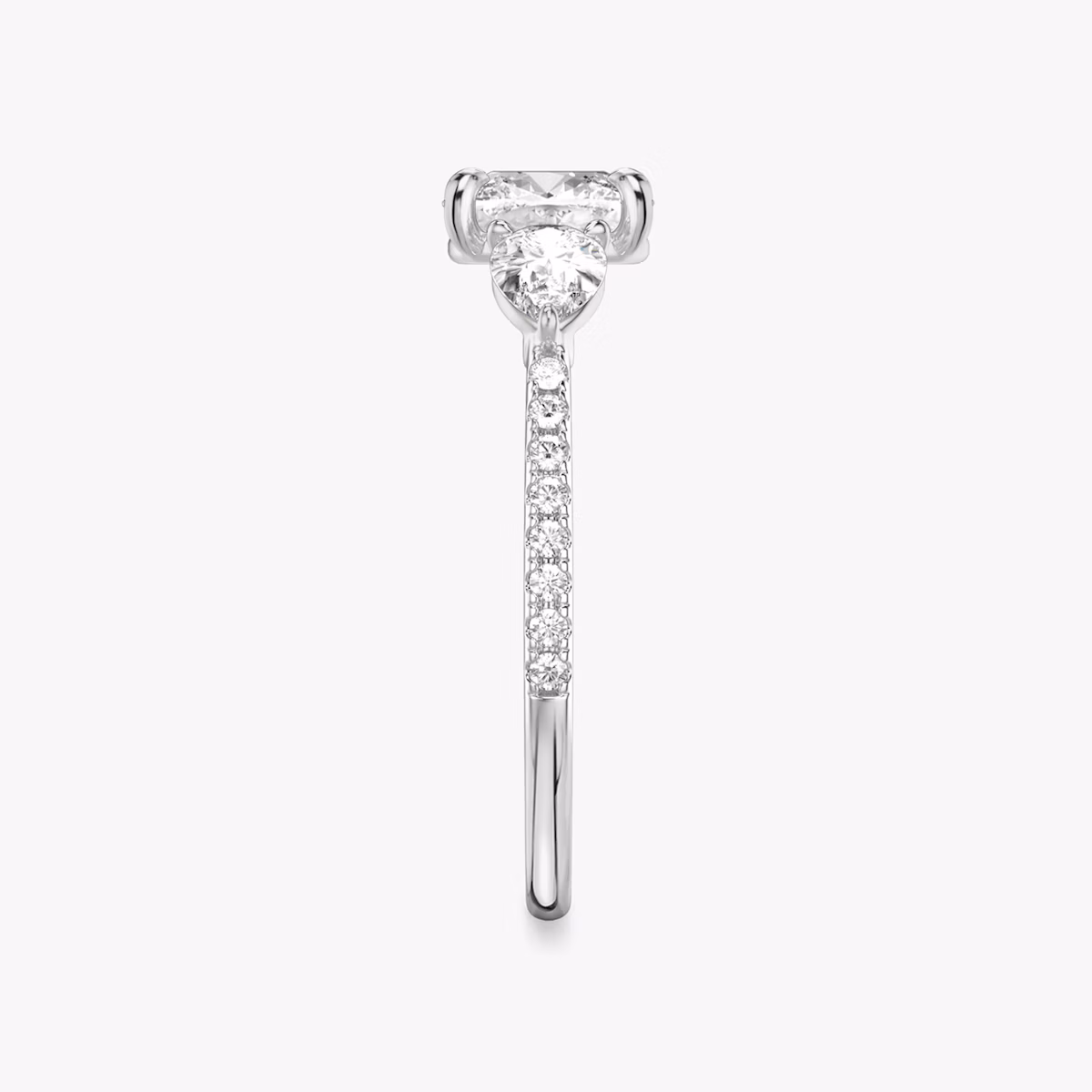 The Three Stone | Cushion | Platinum | bandAccent: Pavé | sideStoneCarat: 0.25ct | sideStoneShape: Pear | diamondOrientation: vertical | caratWeight: other