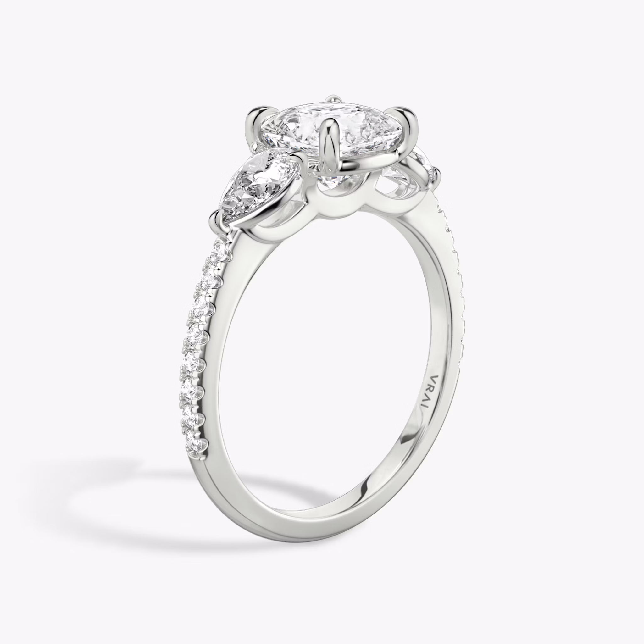 The Three Stone | Cushion | 18k | White Gold | bandAccent: Pavé | sideStoneCarat: 0.25ct | sideStoneShape: Pear | diamondOrientation: vertical | caratWeight: other