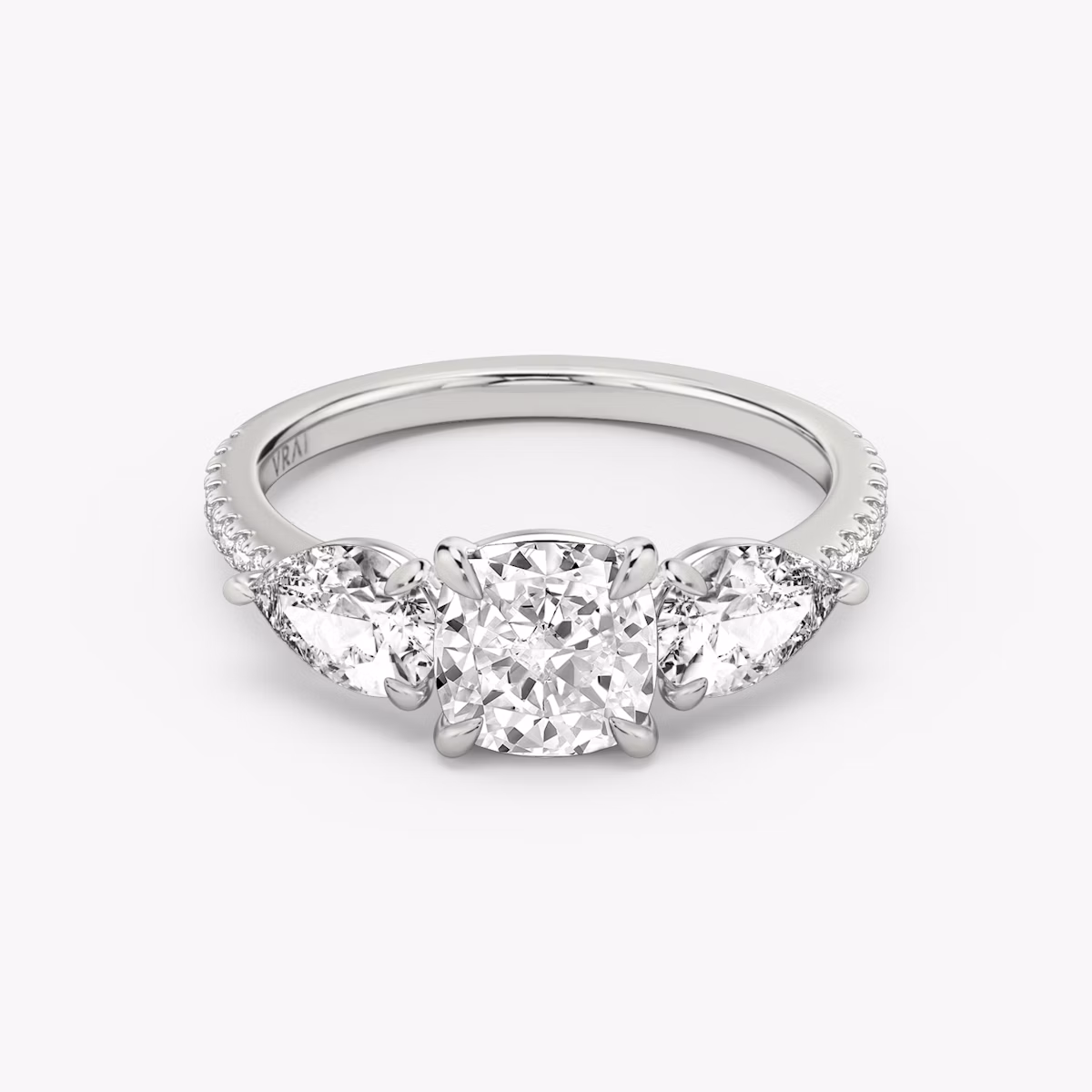 The Three Stone | Cushion | Platinum | bandAccent: Pavé | sideStoneCarat: 0.50ct | sideStoneShape: Pear | diamondOrientation: vertical | caratWeight: other