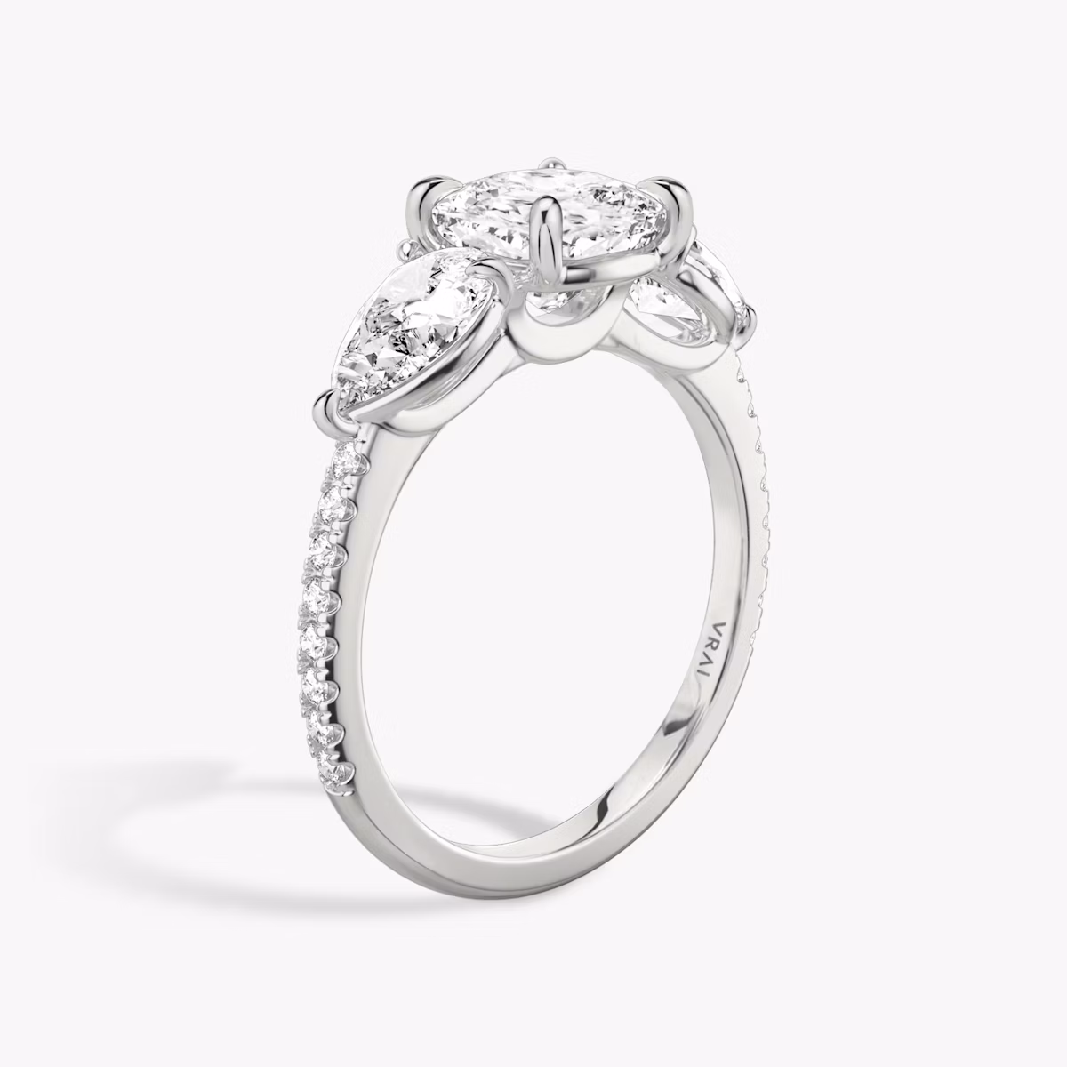 The Three Stone | Cushion | Platinum | bandAccent: Pavé | sideStoneCarat: 0.50ct | sideStoneShape: Pear | diamondOrientation: vertical | caratWeight: other