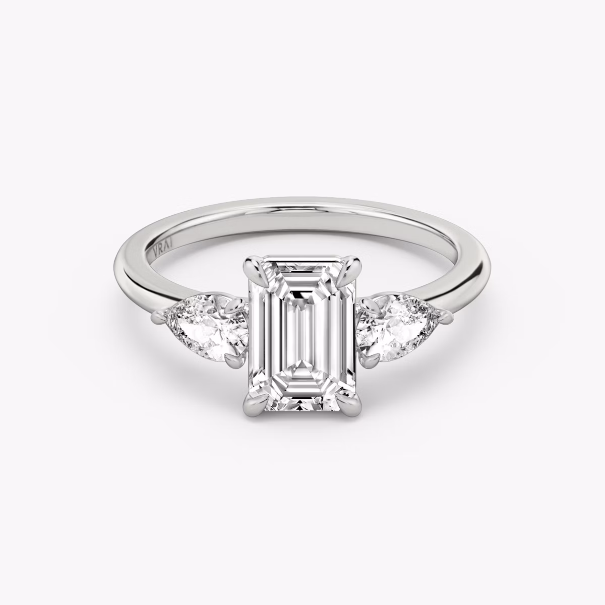 The Three Stone | Emerald | Platinum | bandAccent: Plain | sideStoneCarat: 0.25ct | sideStoneShape: Pear | diamondOrientation: vertical | caratWeight: other