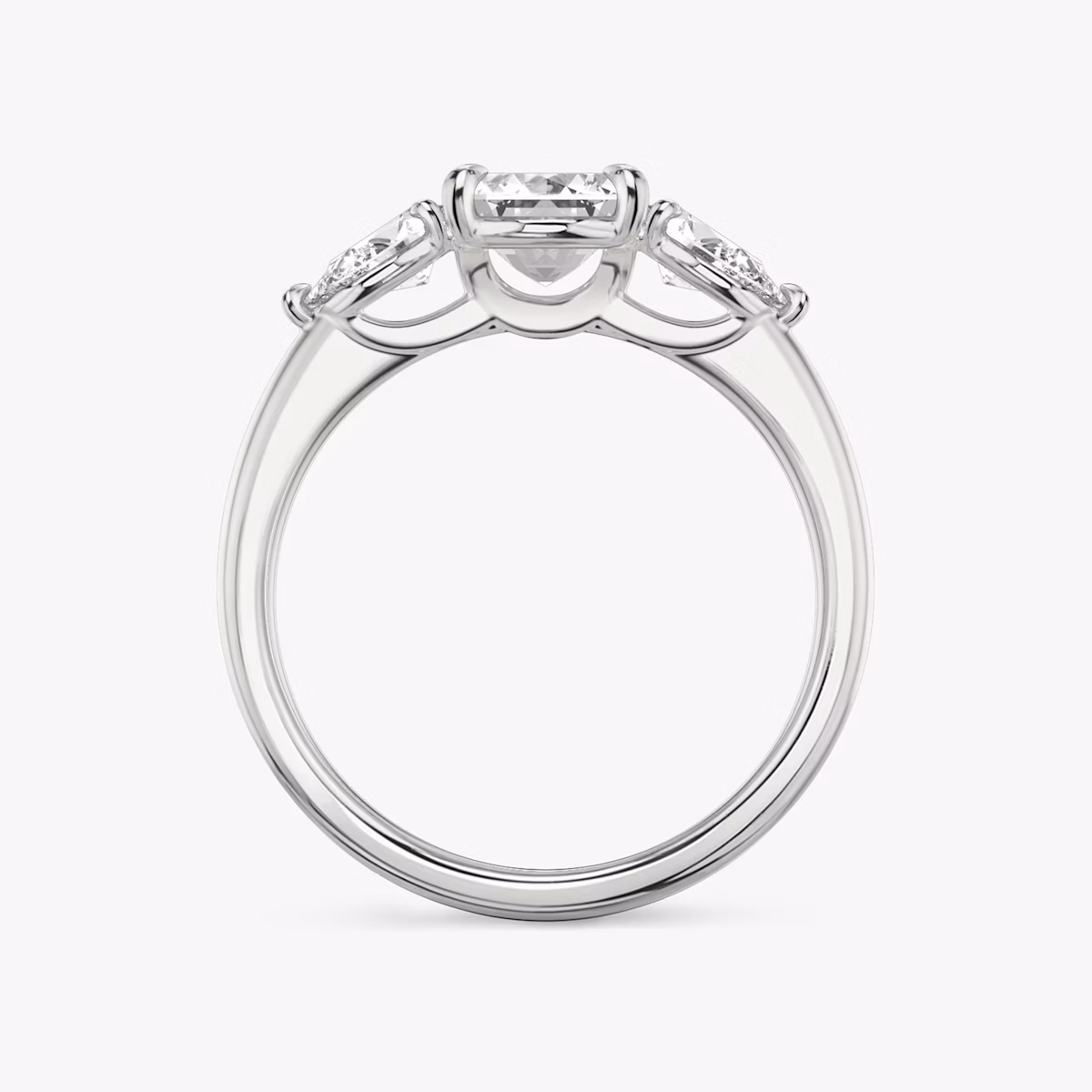 The Three Stone | Emerald | Platinum | bandAccent: Plain | sideStoneCarat: 0.25ct | sideStoneShape: Pear | diamondOrientation: vertical | caratWeight: other