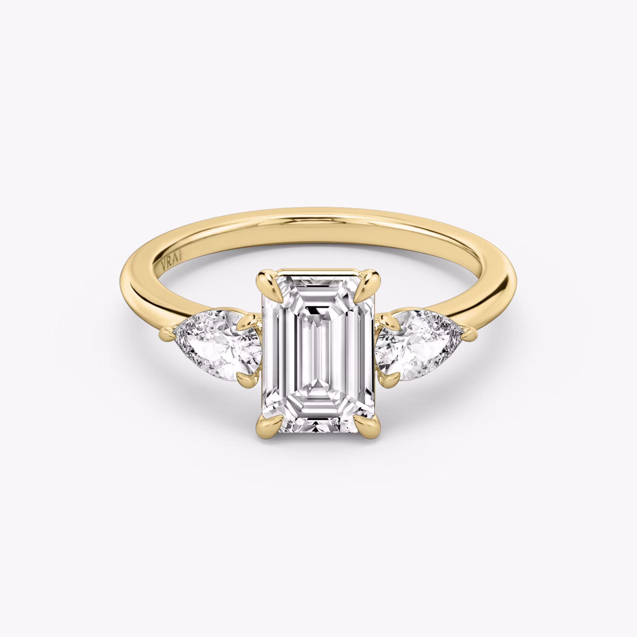 The Three Stone | Emerald | 18k | Yellow Gold | bandAccent: Plain | sideStoneCarat: 0.25ct | sideStoneShape: Pear | diamondOrientation: vertical | caratWeight: other