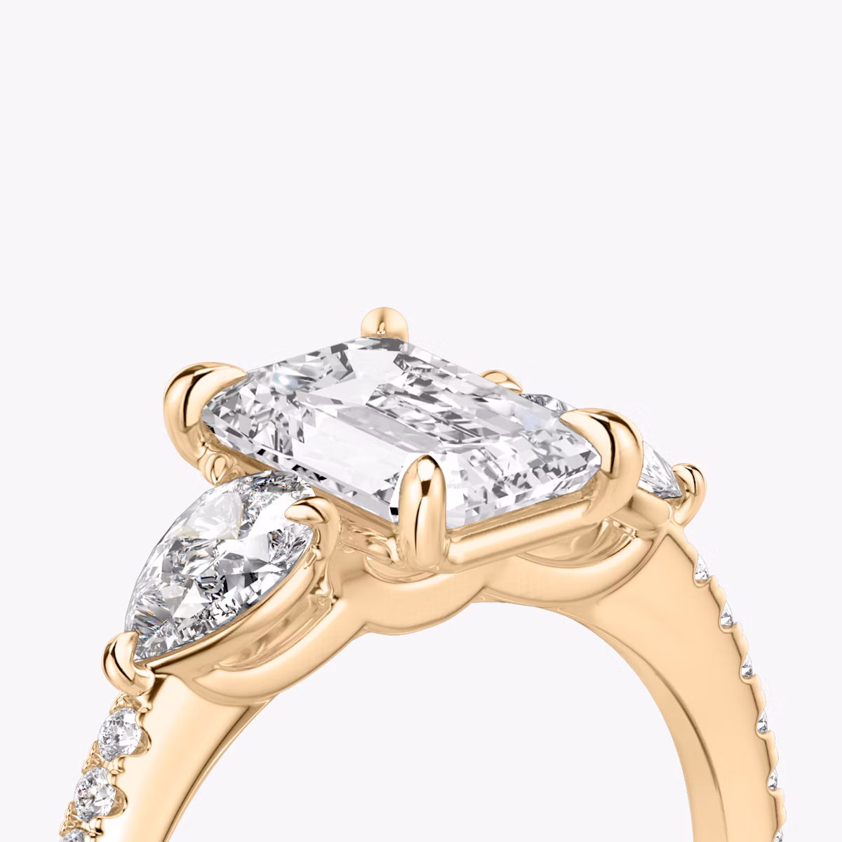 The Three Stone | Emerald | 14k | Rose Gold | bandAccent: Pavé | sideStoneCarat: 0.25ct | sideStoneShape: Pear | diamondOrientation: vertical | caratWeight: other