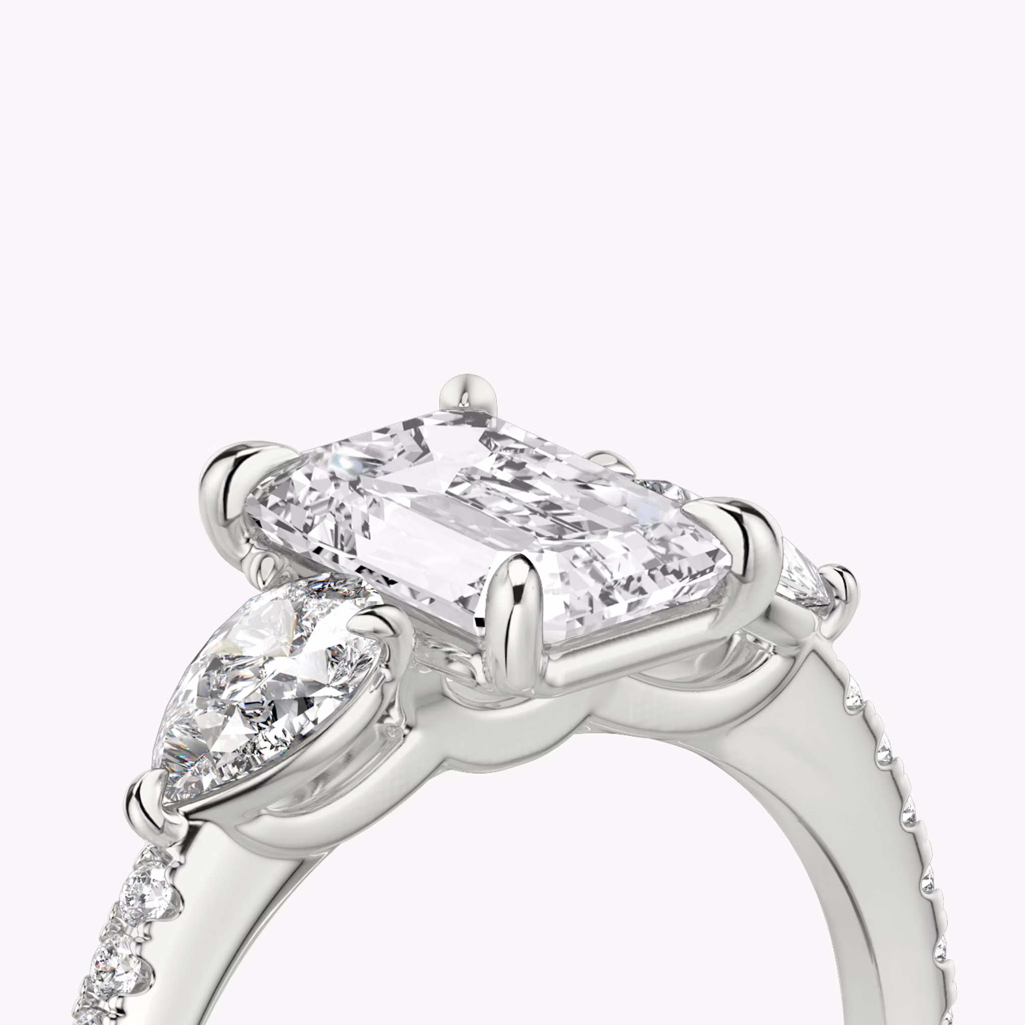 The Three Stone | Emerald | 18k | White Gold | bandAccent: Pavé | sideStoneCarat: 0.25ct | sideStoneShape: Pear | diamondOrientation: vertical | caratWeight: other